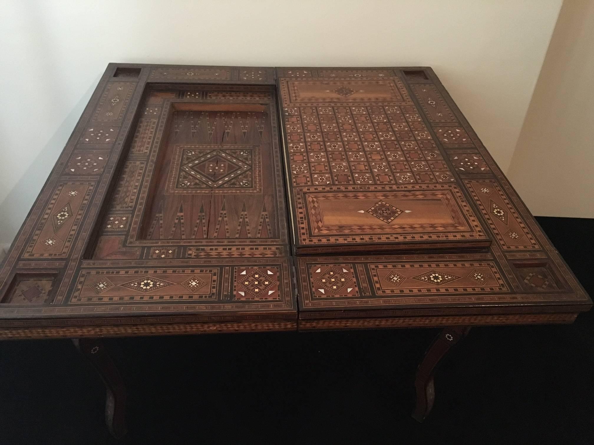 19th century game table inlaid with bone, ebony, mother of pearl geometrical patterns.
Wonderful example of Syrian furniture and is a very pretty decorative piece.