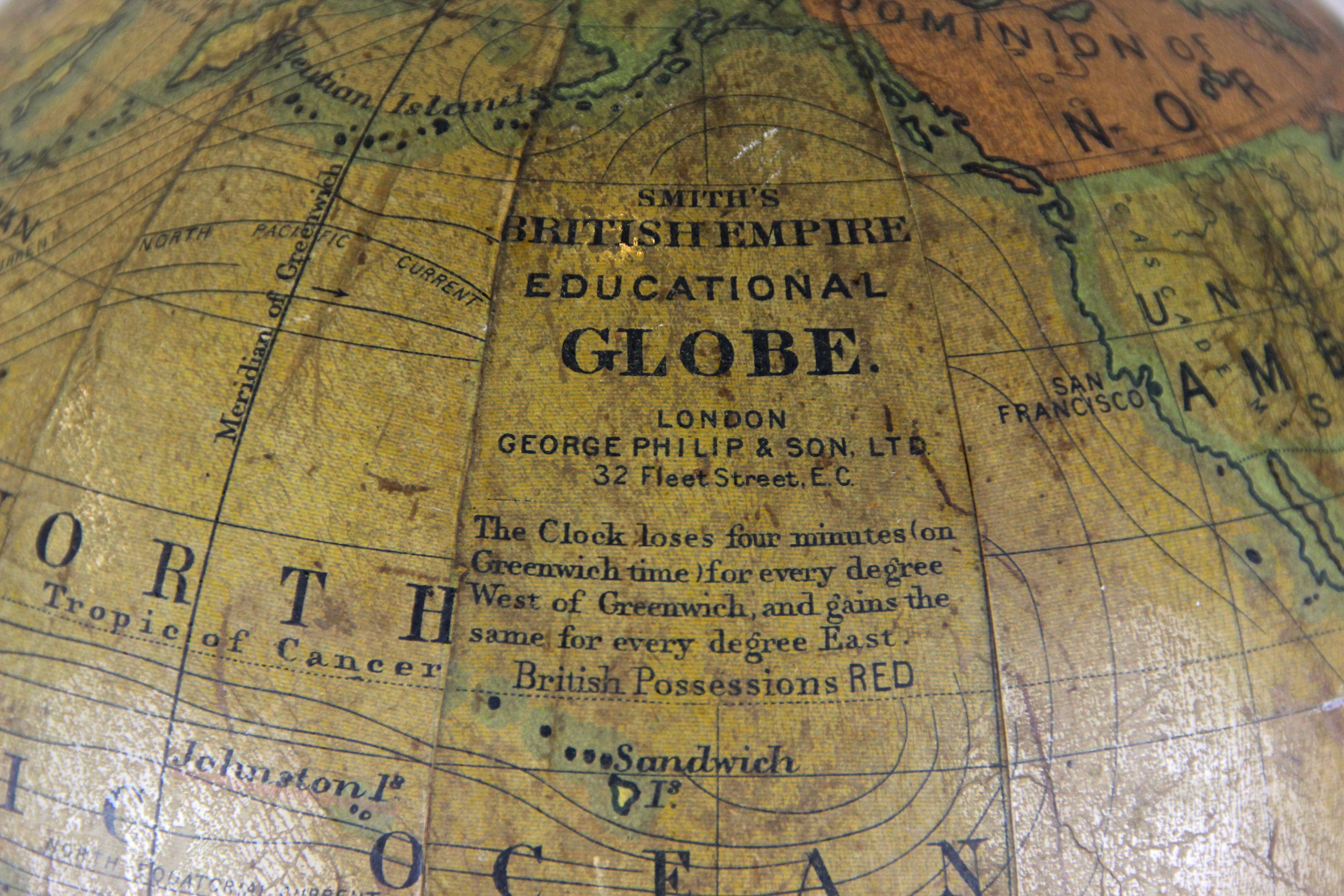 Exceptional 8 inch C. Smith´s British Empire Educational Globe artfully processed by George Philip & Son in London, circa 1890. Presented on the original ebonized base and upright, mounted in a half brass ring, this globe comprises of twelve coated
