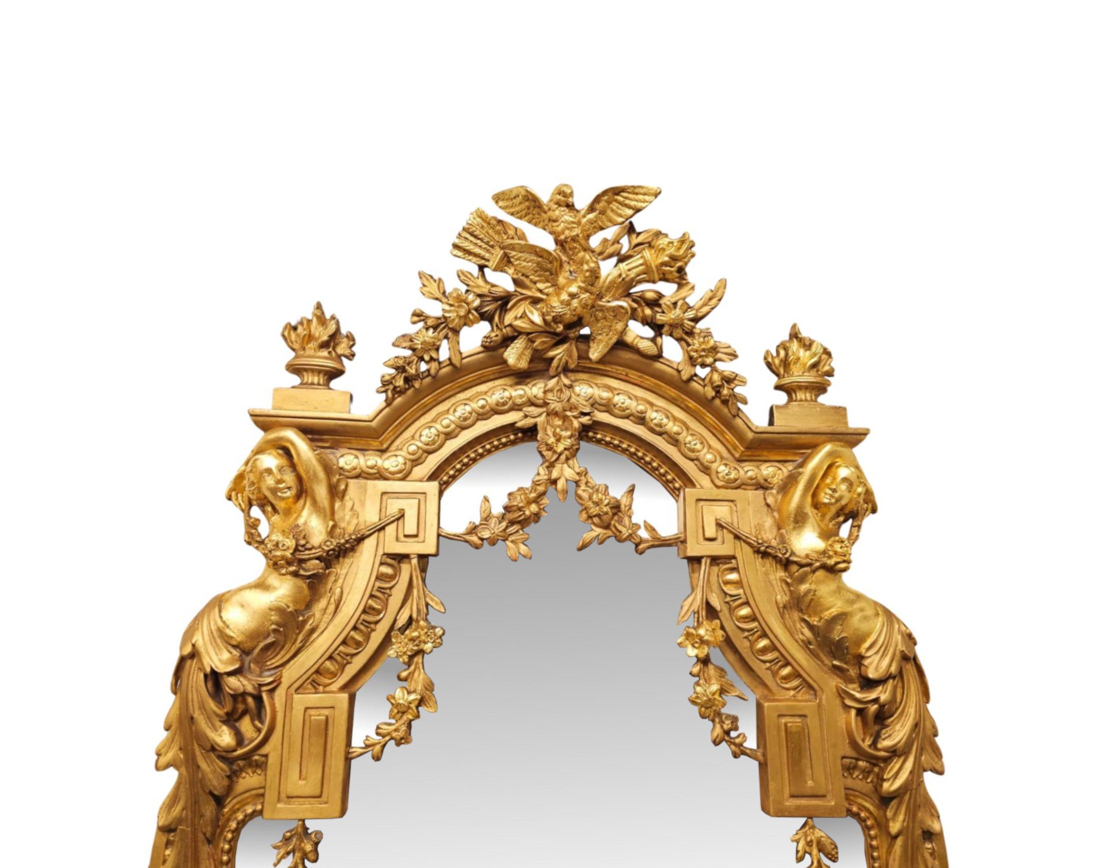 A very rare 19th Century giltwood dressing, hall or pier mirror of tall and narrow proportions and of exceptional quality.  The shaped mirror glass plate is set within a finely hand carved, moulded and fluted giltwood frame with fabulous greek key,