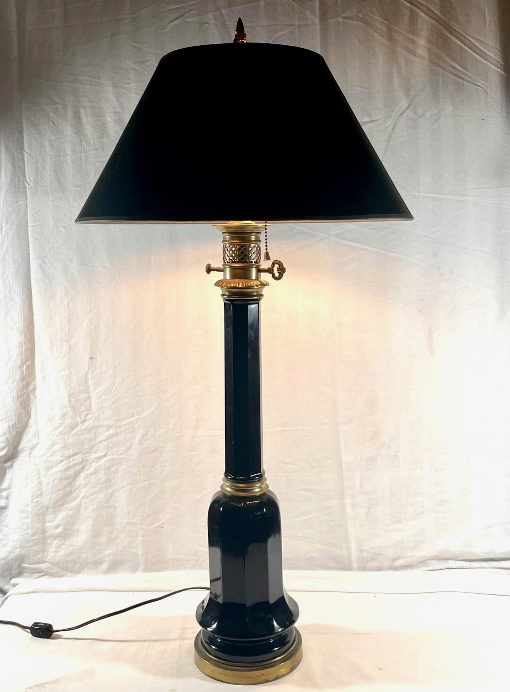 19th Century tall black glass table lamp.

Victorian tall black glass brass mounted table lamp. A decorative and timeless design, this oil lamp is now converted to electricity. The stylish lamp is fitted with a custom black paper shade.
Condition