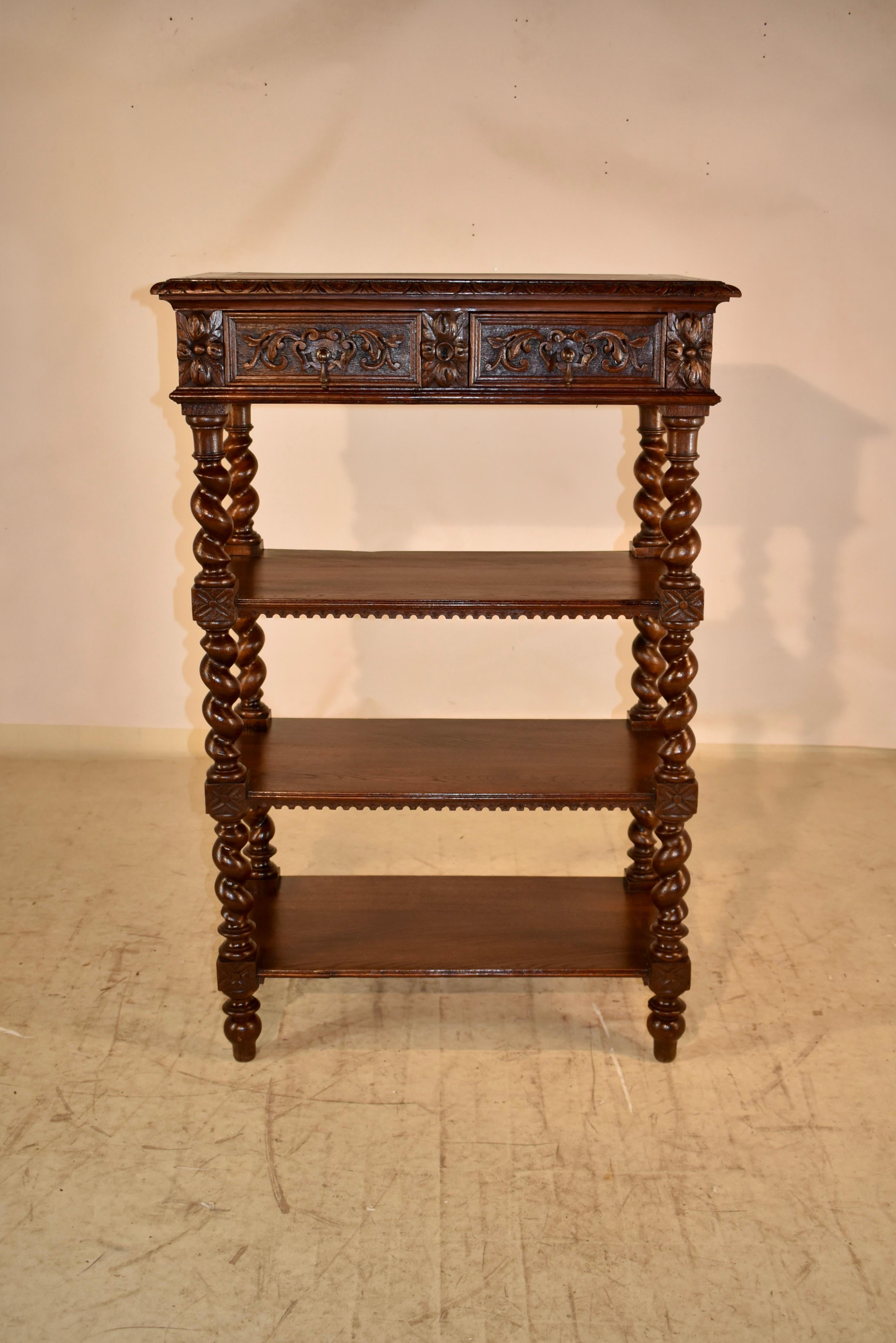 19th century tall oak dessert buffet from France. The top is banded and has a beveled and carved edge around the top, following down to paneled sides and two paneled and hand carved decorated drawers in the front. There are three lower shelves,