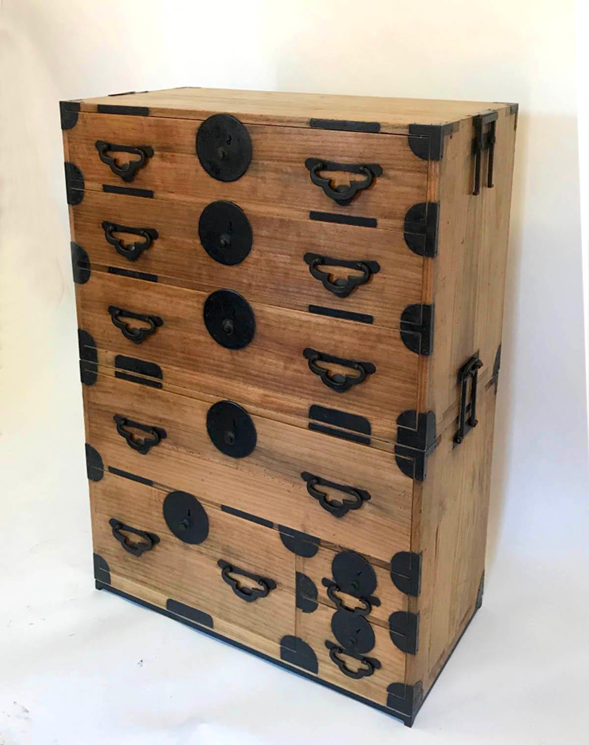 Tansu with seven graduated drawers. All original hardware; hand-forged three leaf clover pulls. Bamboo nails. Sits on a custom iron base. Functional and very pretty. 