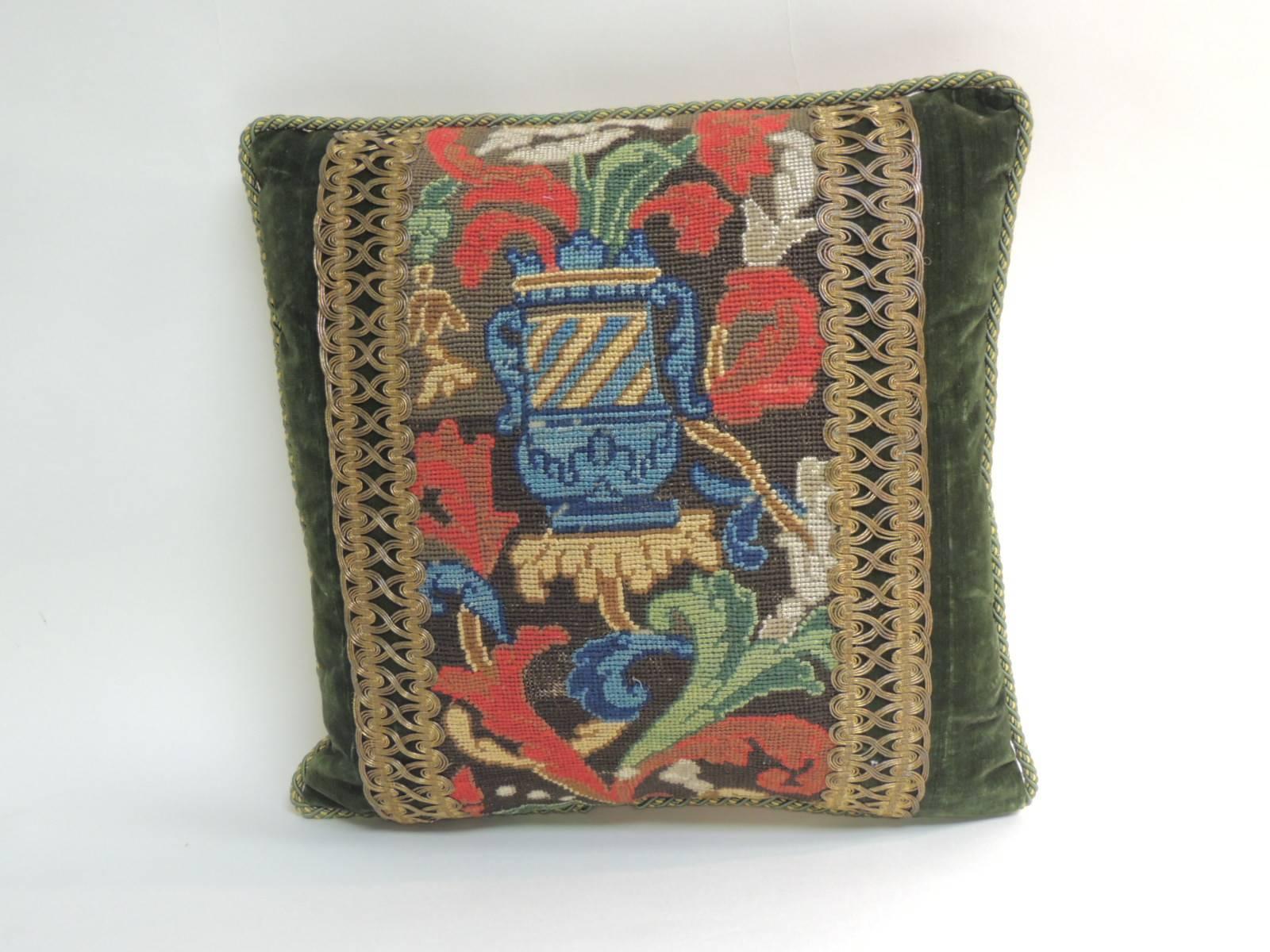 One-of-the-kind: 19th century needlepoint colorful tapestry in the center of the pillow. Decorative one-of-a-kind pillow embellished with a 19th century metallic woven gold trim. Decorative pillow antique textile framed with 18th century hunter