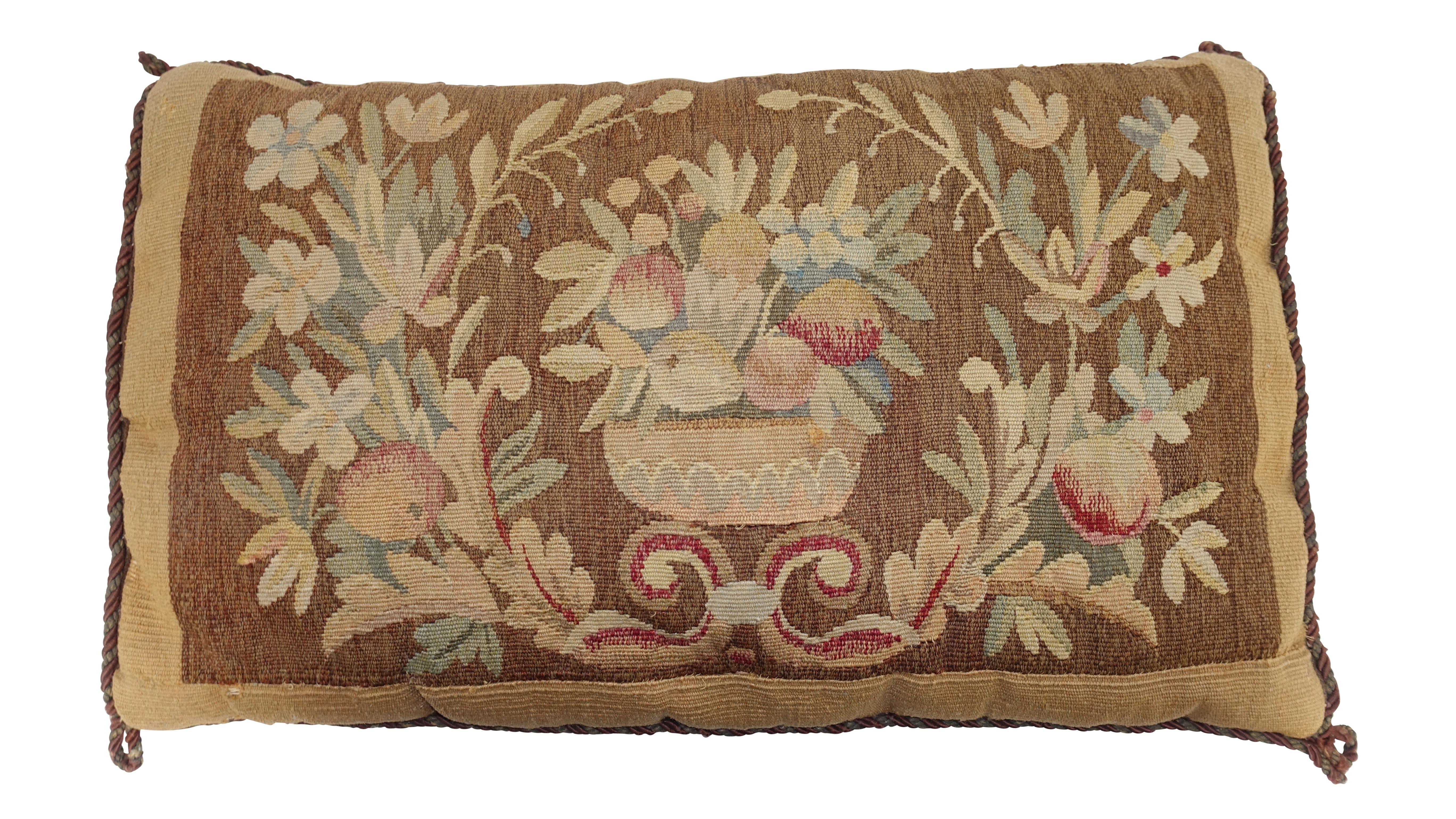 Antique tapestry fragment with basket of fruit and floral design made into a pillow with down cushion. Continental, early 19th century.
Shows expected light wear and age.