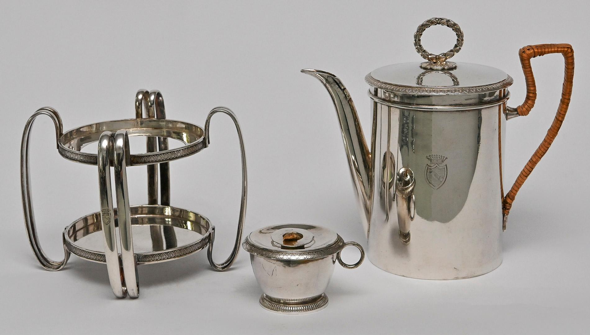 Tea, coffee or water pot with rechaud, Vienna about 1817
silver 15 lot, like more as sterling silver Engraved coat of arms 
The weight is 860 gr Silver, the content of the jug is 0,6 lit. 
A very fine quality of workmanship, with knob as a laurel