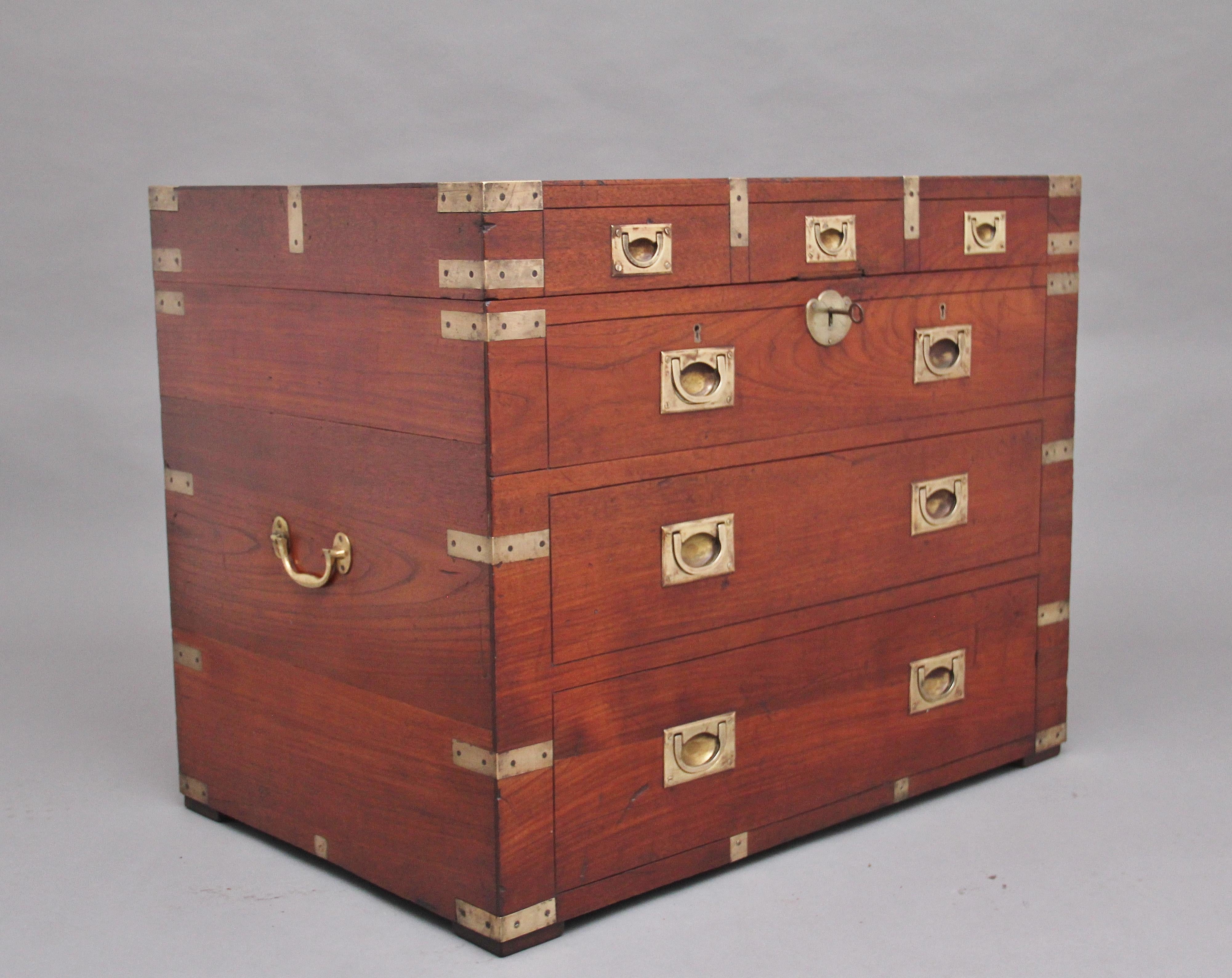 19th century teak and brass bound military / Campaign trunk, the trunk having brass carrying handles to the sides, the front having brass recessed handles with the look like it has three short over three long drawers but in fact are faux drawers,
