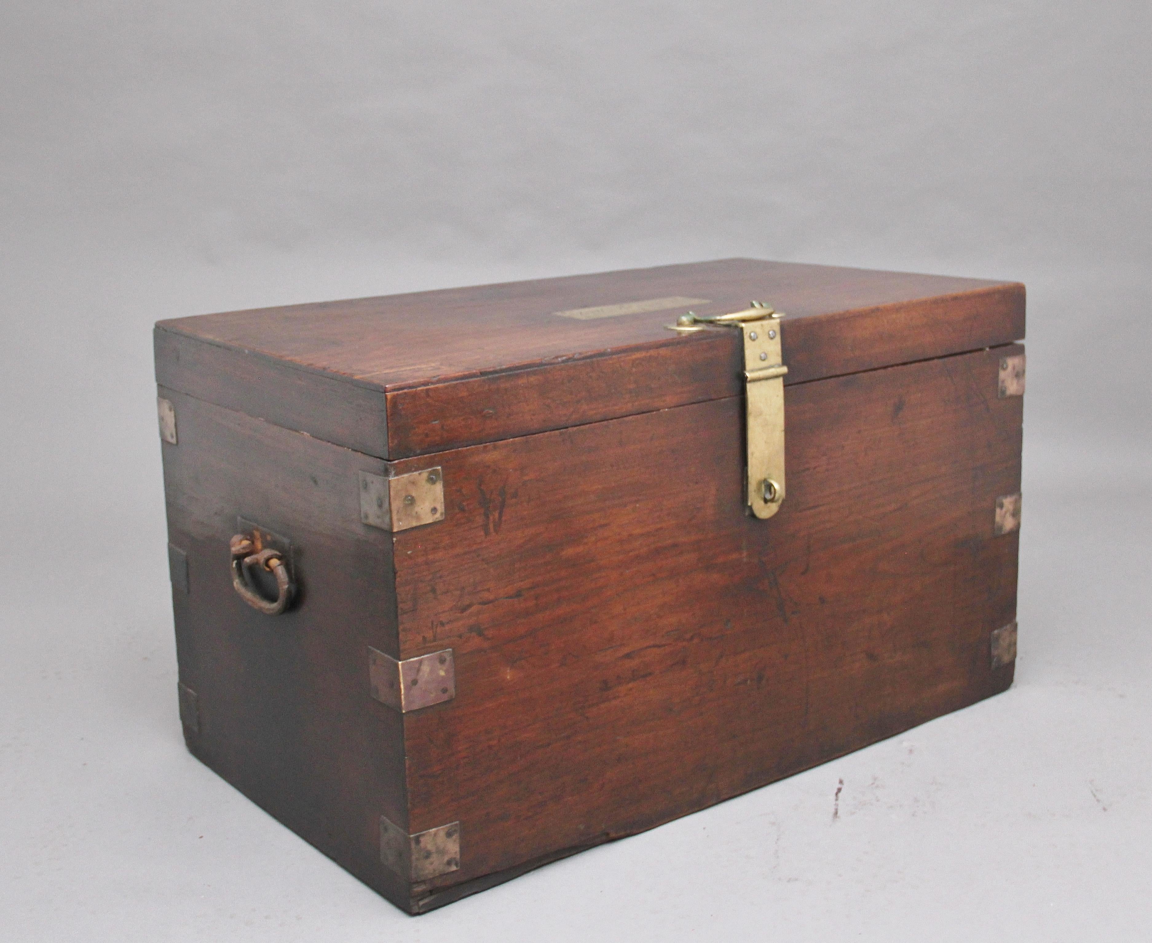 19th century teak and brass bound military / campaign trunk with iron carrying handles on the sides and a lovely brass hasp on the top and front with a handle on the top to open it with. The top has a brass plaque marked “J M Bennett” and the date