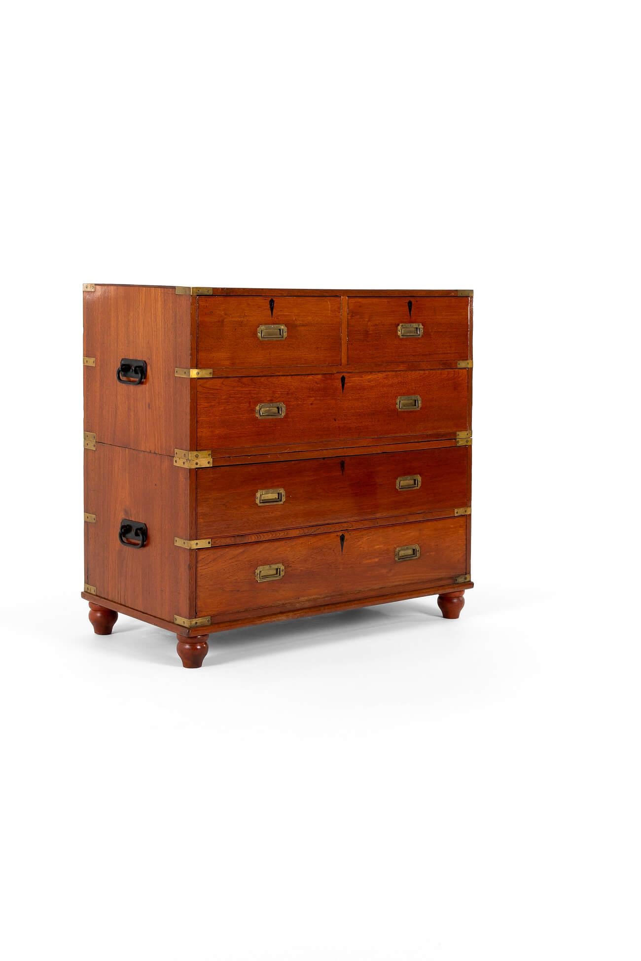 An English 19th-century campaign chest in two parts with removable feet in teak.

The chest has two short drawers, a deep second draw below, and two long drawers to the bottom half.

Each of the two sections has a pair of heavy iron handles on