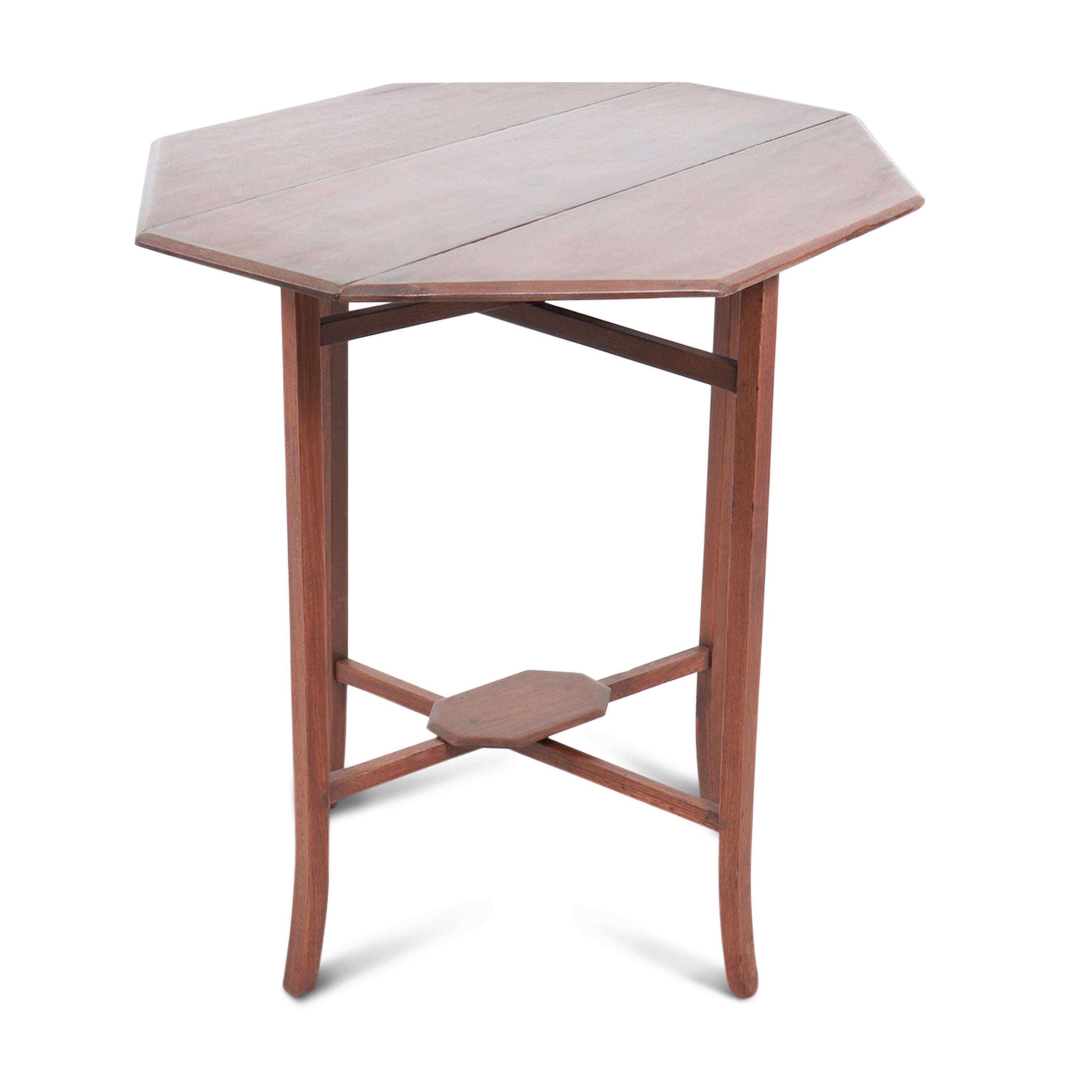 A teak folding table, featuring a minimalistic design with clean lines. This charming and versatile piece combines functionality and quality. 