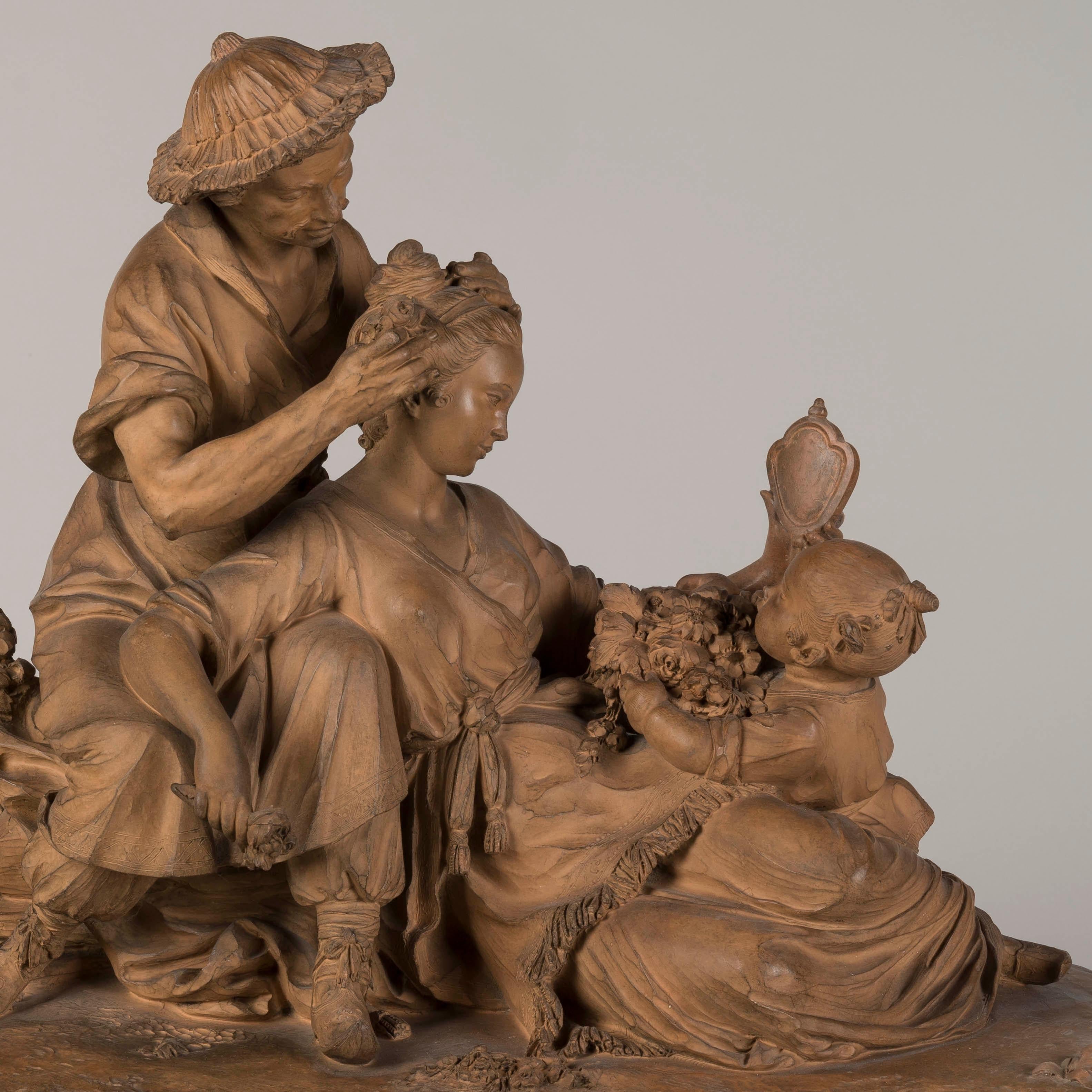 A Chinoiserie Sculptural Group
After François Boucher

This refined terracotta sculpture of a lady at her toilette was a popular motif first depicted in a painting by François Boucher, dated 1742, and known as 