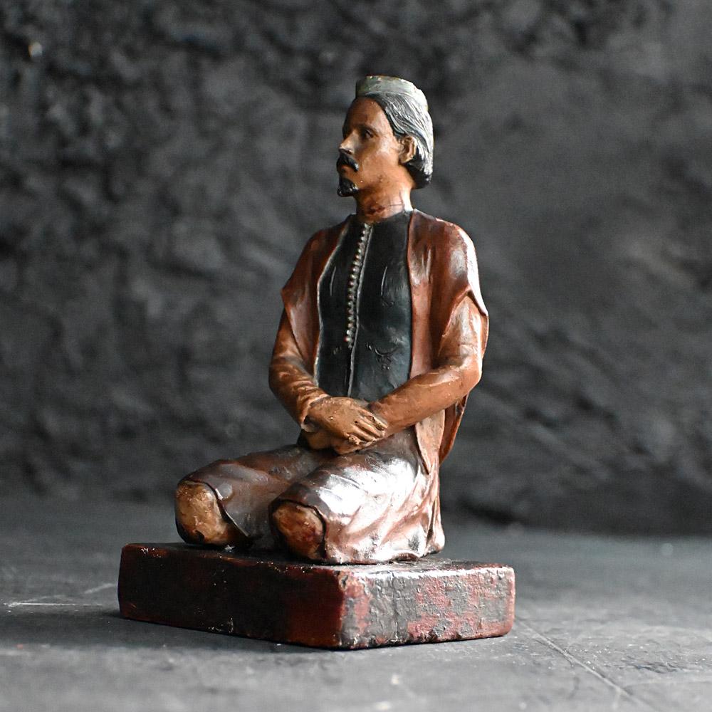 19th Century Terracotta Hand Painted Indian Seated Figure 
A superb example of a late 19th Century hand painted Indian terracotta seat male figure statue. Detailed in religious attire with prayer hat and salwar clothing (loose fitted cotton