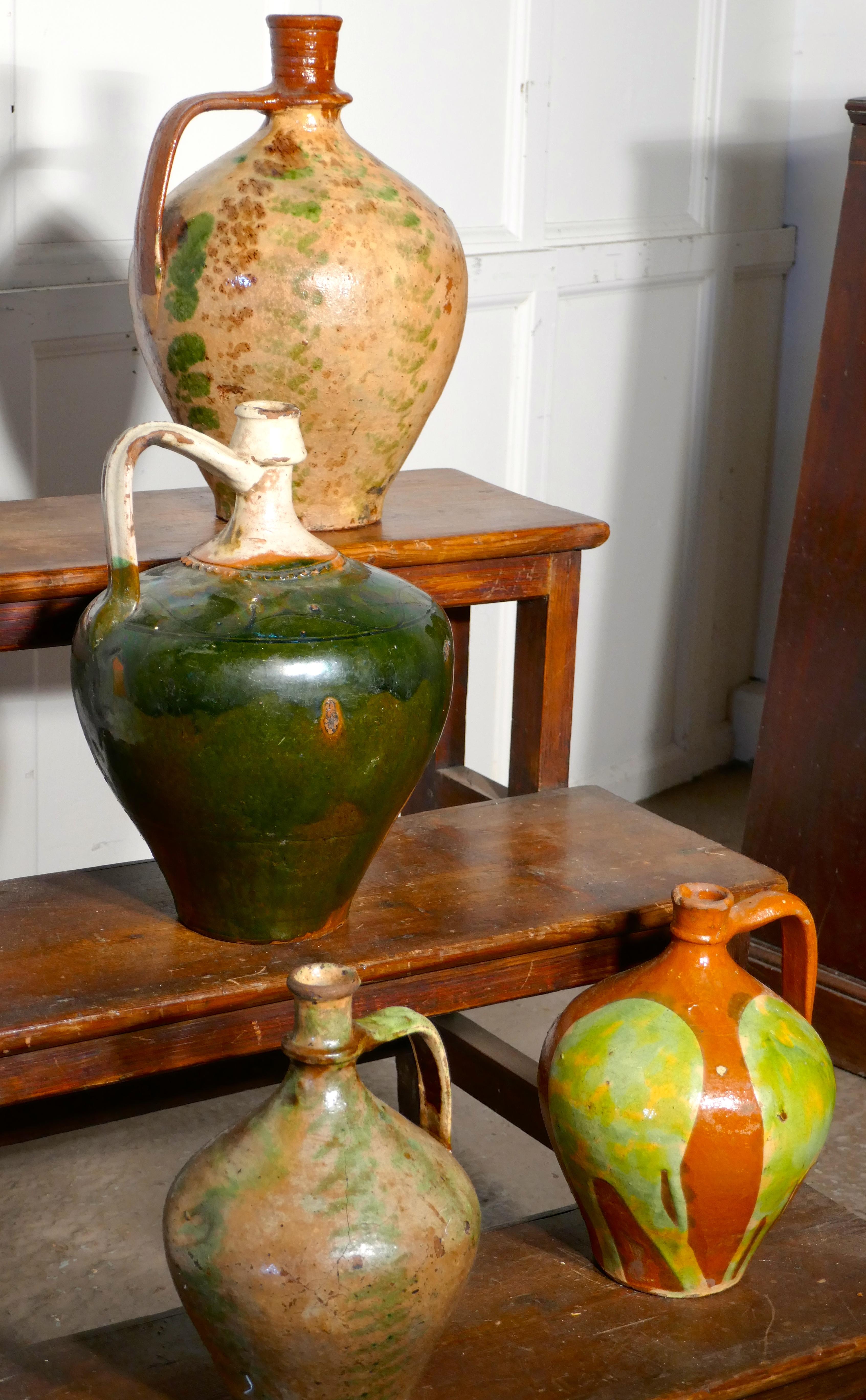 19th century terracotta olive oil jug from Portugal 

A wonderful Portuguese antique olive oil jar, this piece has a beautiful shape, handle to one side and a very attractive pattern under the glaze, not perfect but in very good condition for its