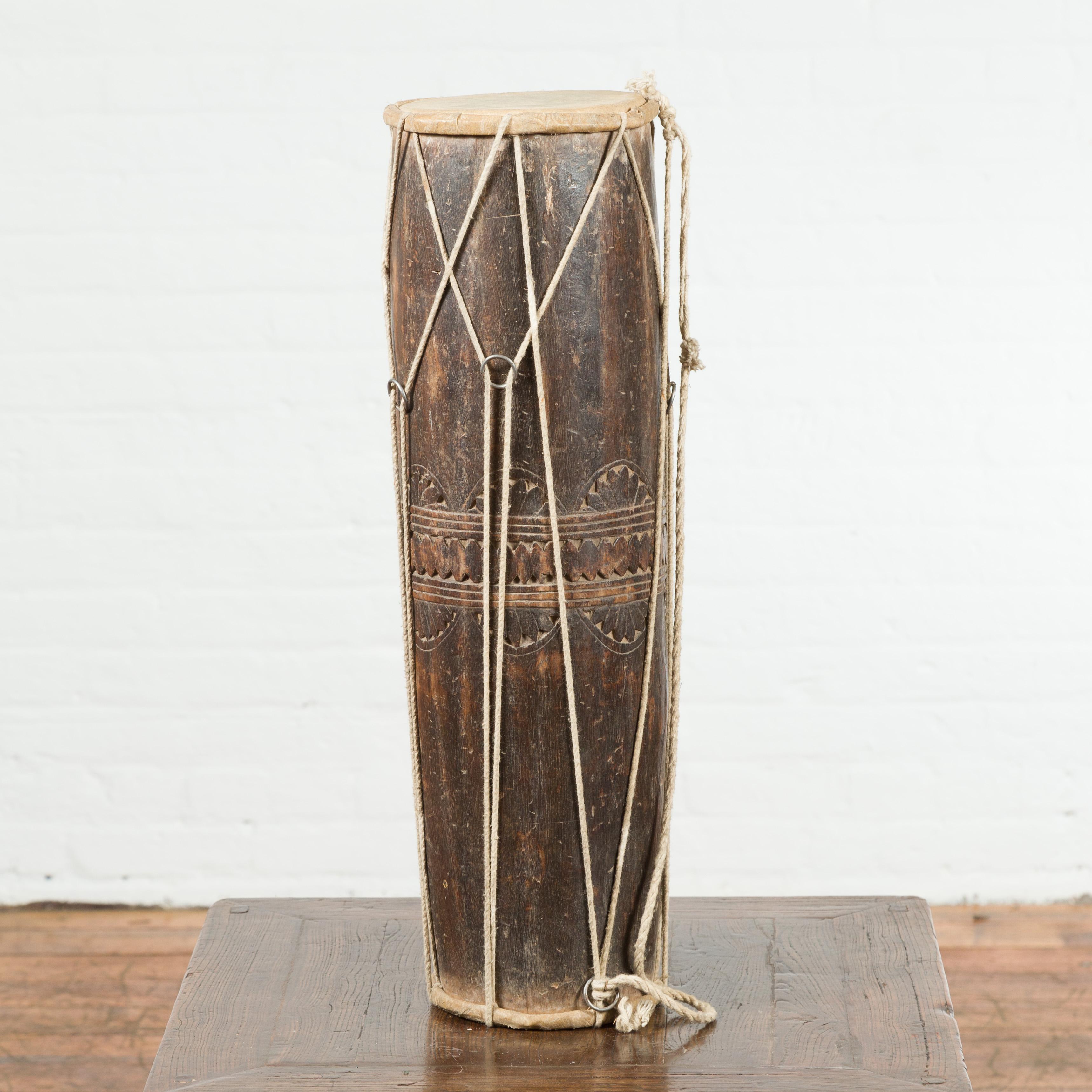 An antique Thai ceremonial wooden drum from the 19th century, with leather drumhead. Sculptural and freestanding, this 19th century drum, created in Thailand, will make for a great decorative accentuation in any home. Topped with a leather drumhead