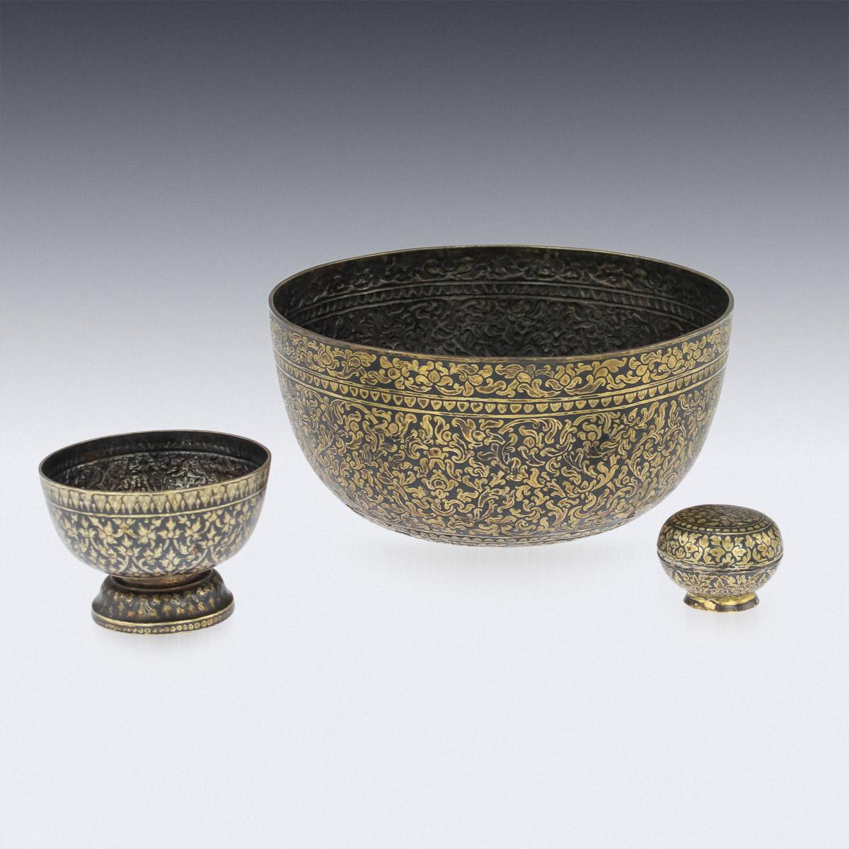 Antique mid-19th century Thai extremely rare and fine set of solid silver niello bowls, of various sizes, these betel leaf holders, with engraved gilt floral and foliate decoration, come in a set of three and the smallest bowl set with a lid.