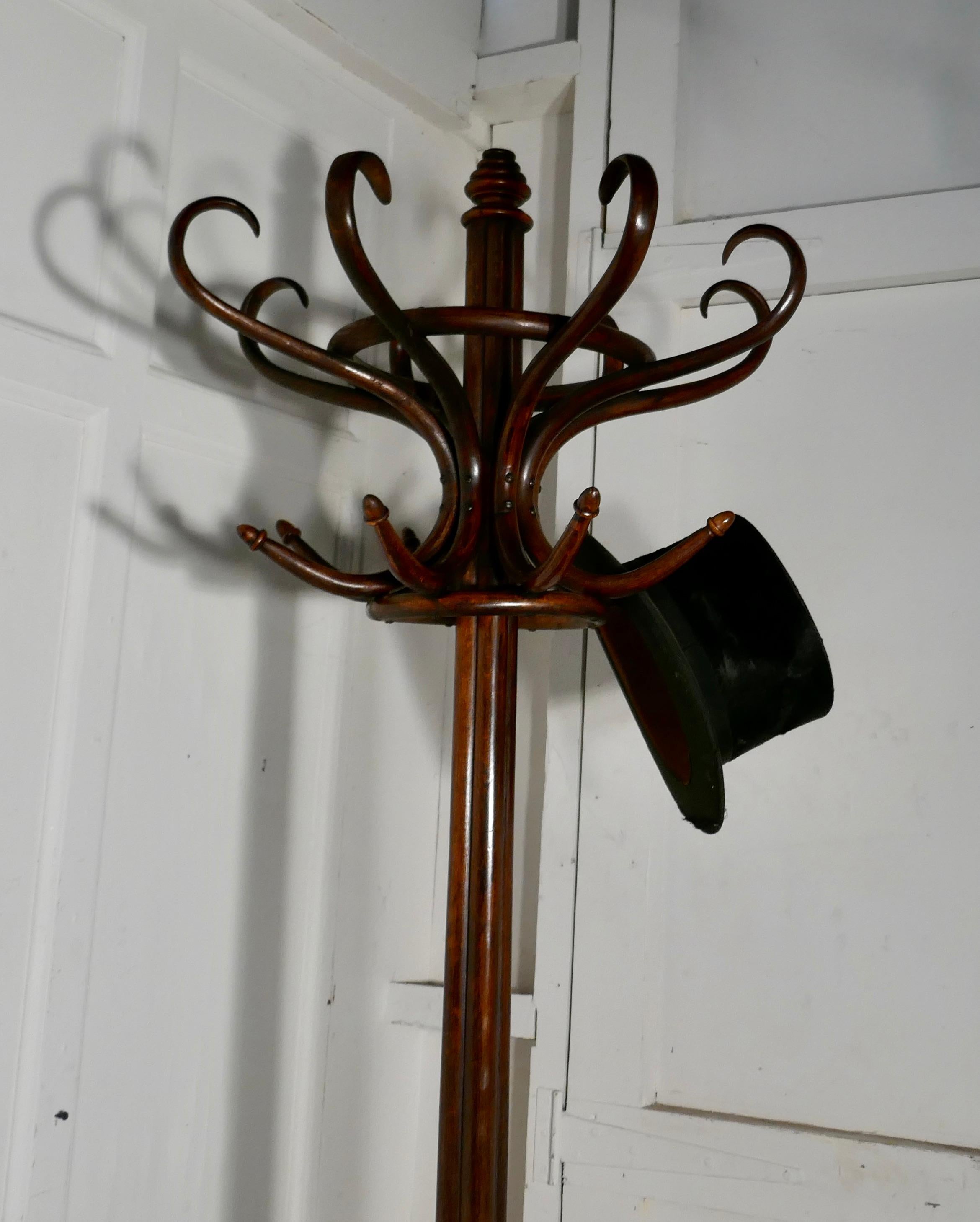 19th century Thonet bentwood hall stand

This is an Unusual large hat and coat hall stand, made by Thonet it has 8 large curved bentwood hat hangers and 8 coat hooks at the top and 4 large scrolling Legs forming the umbrella receptacle at the