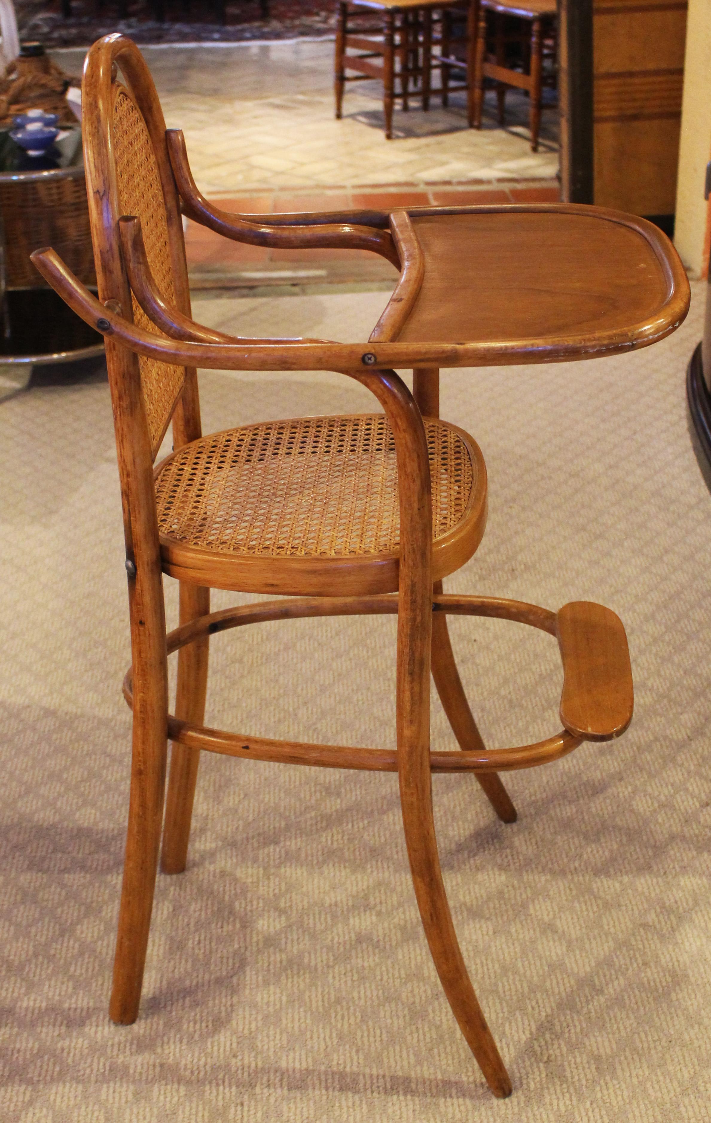 4th quarter 19th century Thonet type bentwood high chair. Beech wood of warm honey tones. Restored cane seat, back & old refinishing. Provenance: a farm in Blanzy, Burgundy and by descent. 37 3/4