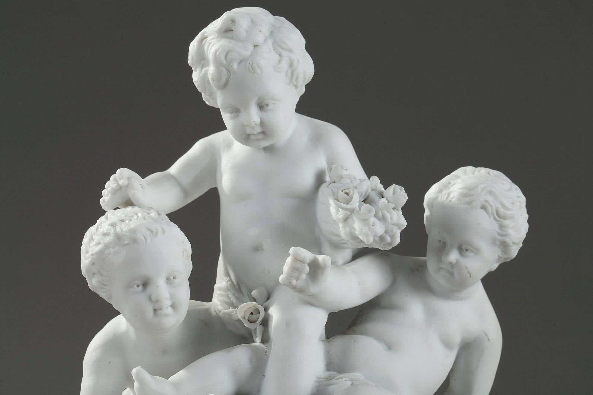 Small bisque? porcelain? groups depicting children playing. Two of them are holding garlands and bunches of flowers, and the third group, a cup and a grape. They are set on a fluted circular base. Apocryphal Sevres mark underneath. Manufactured in