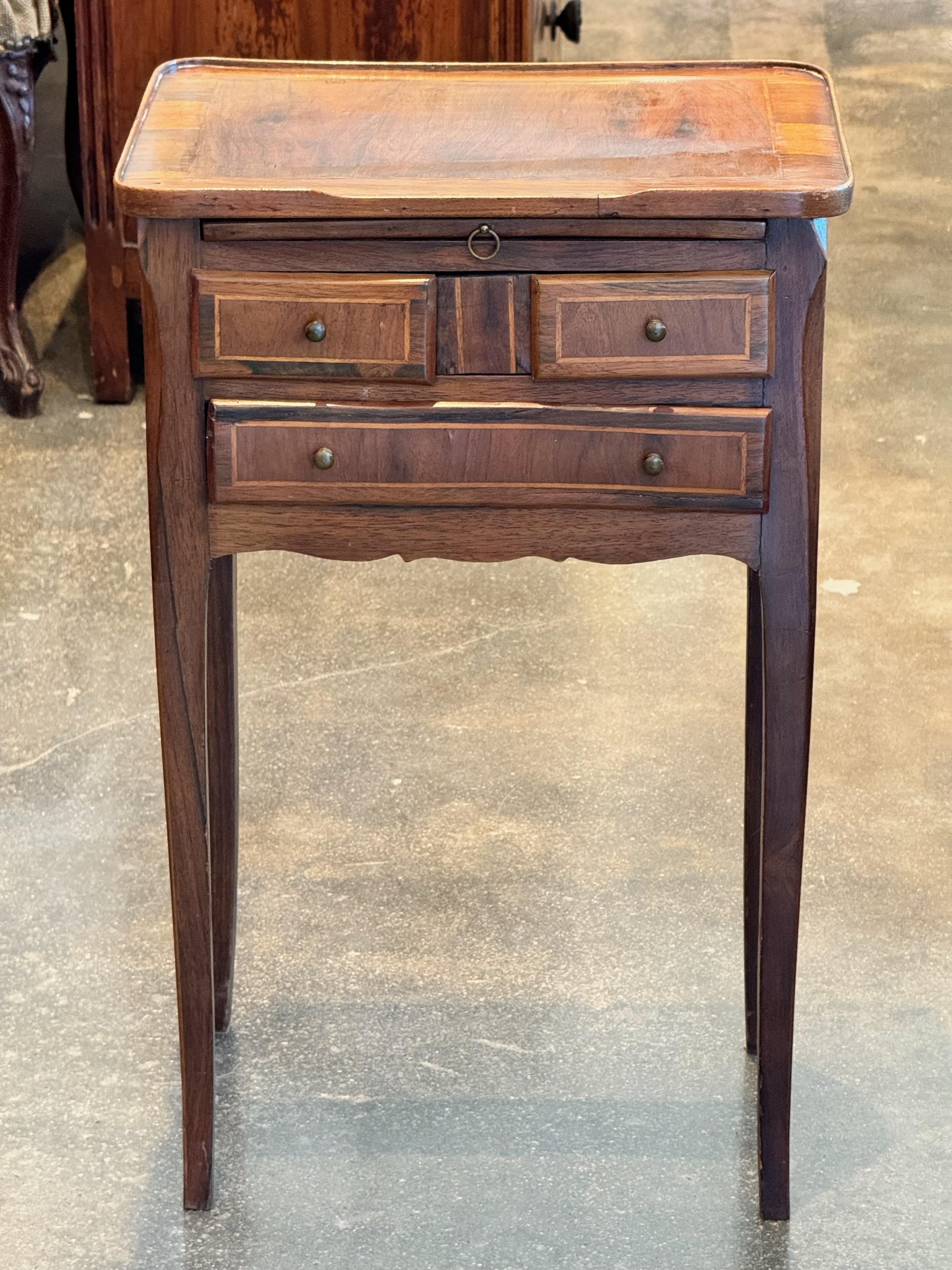 A cute French side table. This piece has three drawers and lots of charm.