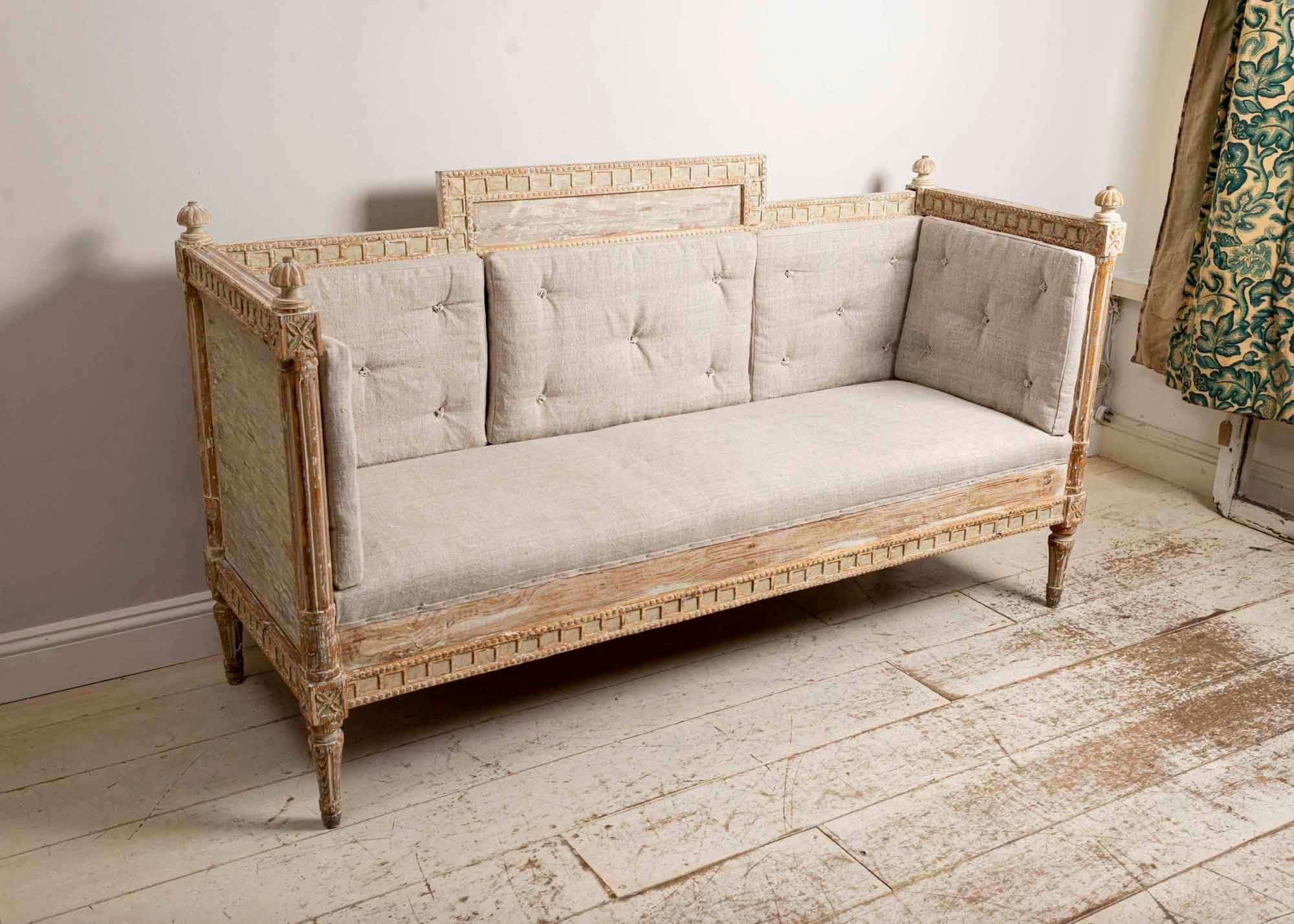 Early 19th century Gustavian high back sofa featuring unusual decorative detail. Reupholstered in a vintage French linen fabric. In very good condition.
 