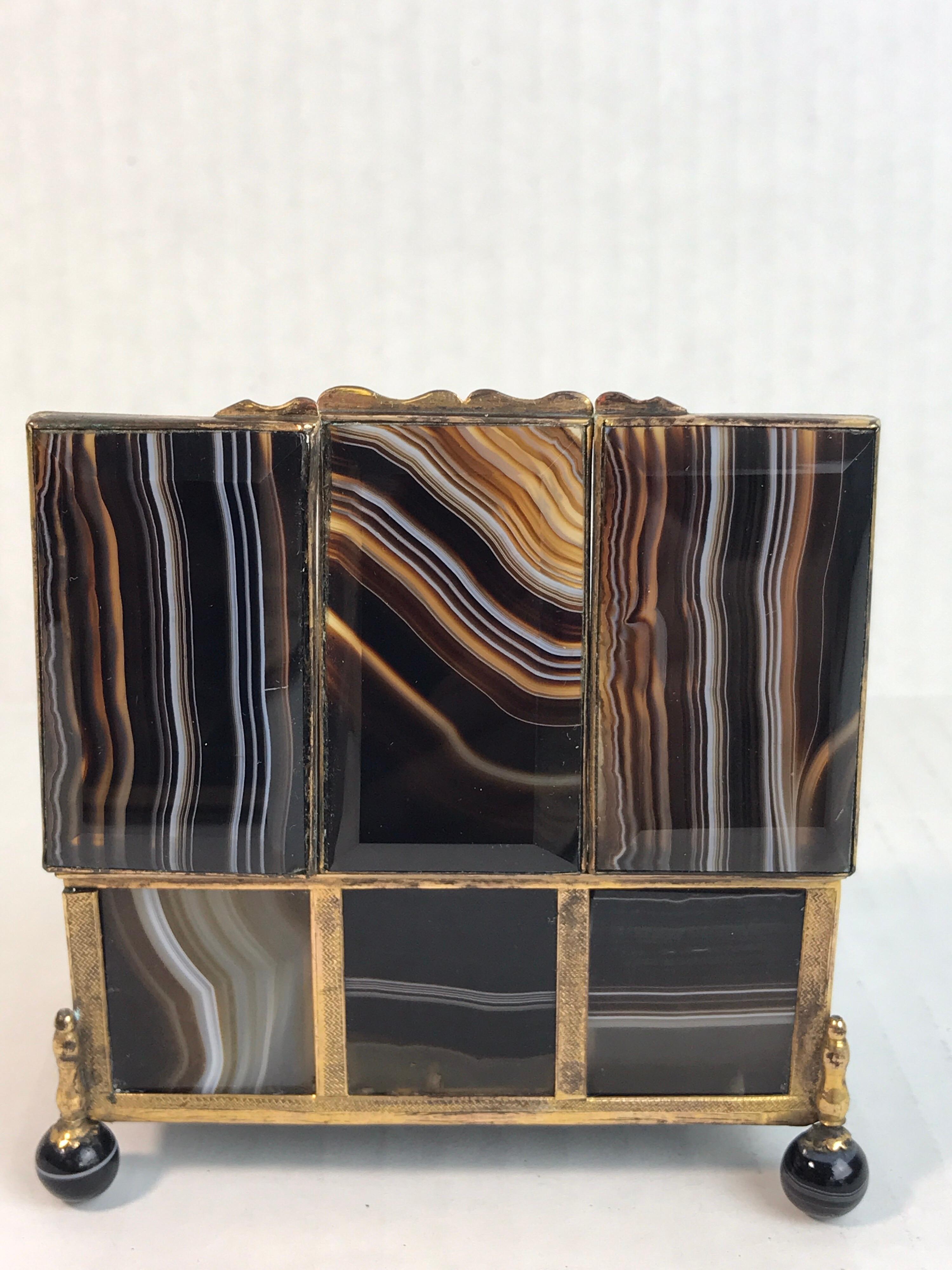 19th century three-section specimen agate and ormolu box, Of rectangular shape, made of 14 individual ormolu-mounted agate panels, the top three beveled, raised on four agate ball feet. Each compartment is approximately 1.25
