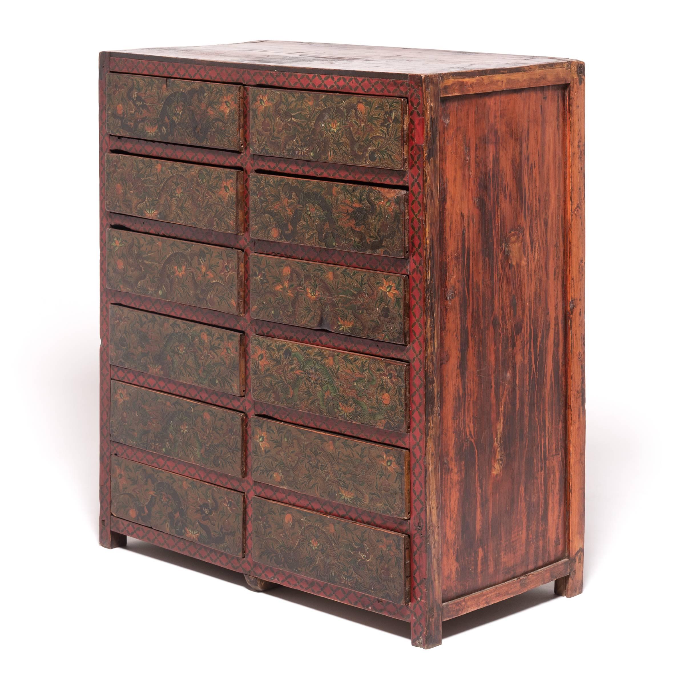 The number 12 figures prominently in Tibetan astrology, making this simple chest’s dozen drawers the perfect canvas for a Tibetan artisan to note the year of the dragon. Tibetan astrology recognizes a 12-year cycle, characterized by 12 animals,