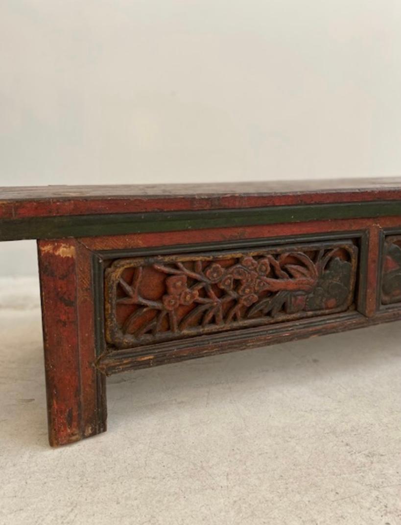 Tibetan bench in carved hand painted softwood serving as an altar