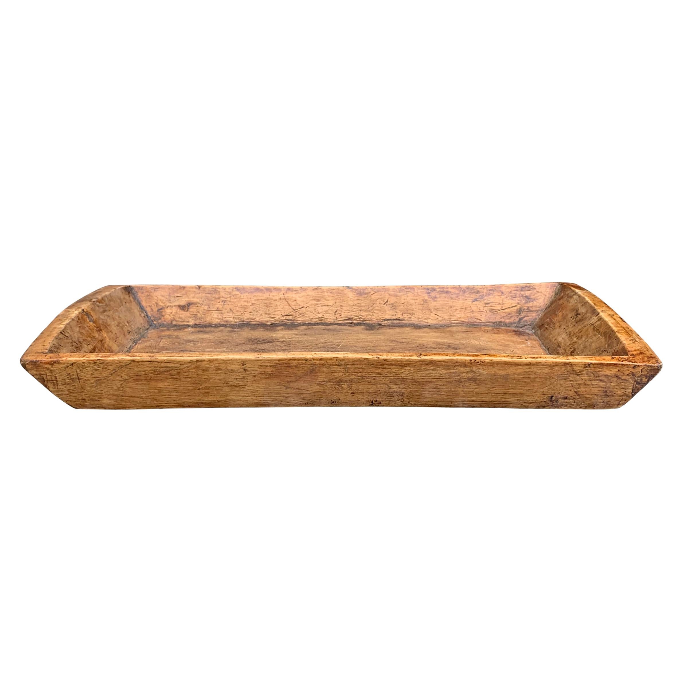 A wonderful 19th century Tibetan hand carved wood tray with tapered sides and a wonderful patina.