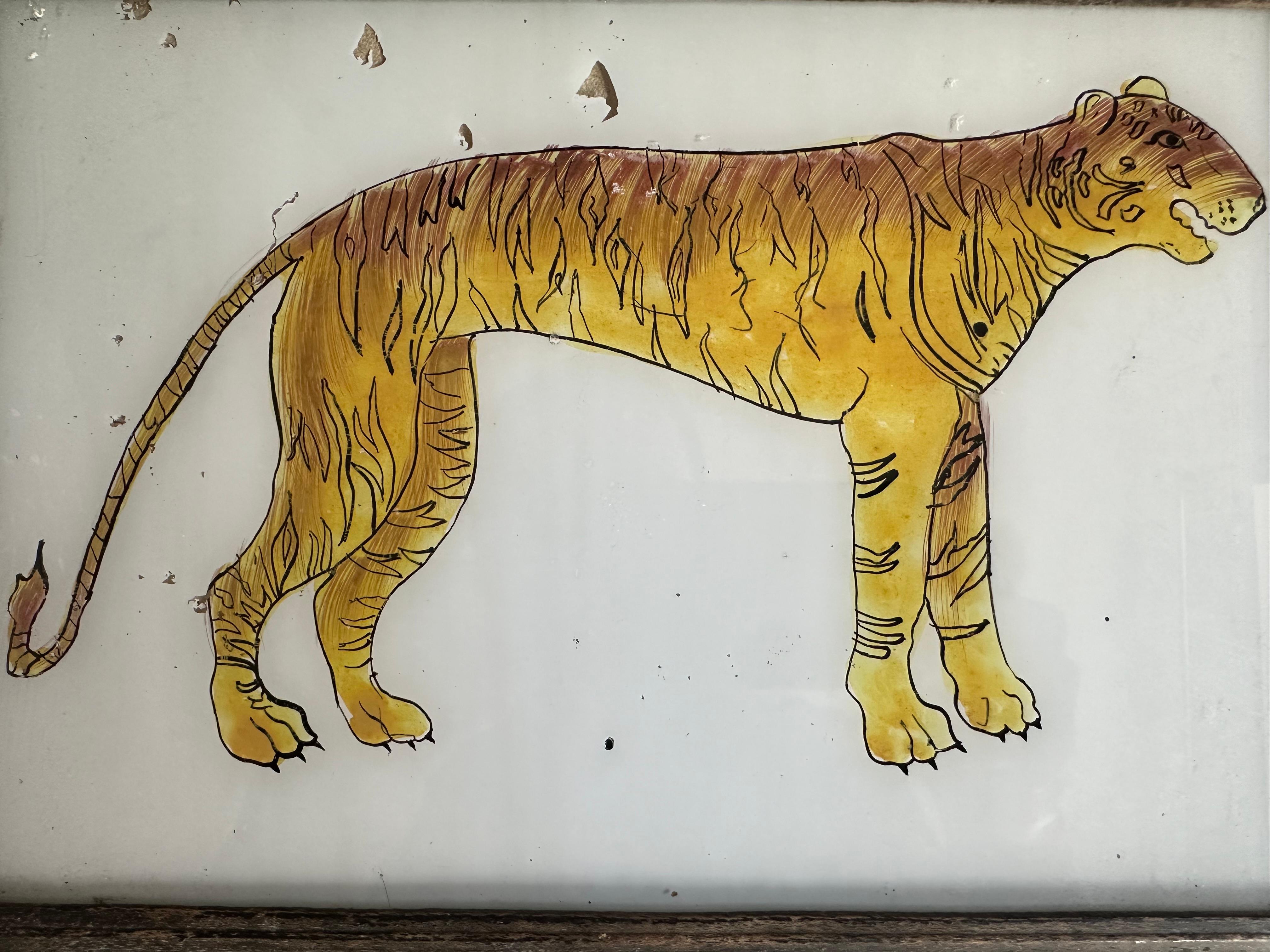 This striking 19th-century tiger portrait captures the majesty and power of one of nature’s most iconic predators. The artist's attention to detail is evident in the rendering of the tiger's distinctive stripes, intense gaze, and muscular form,