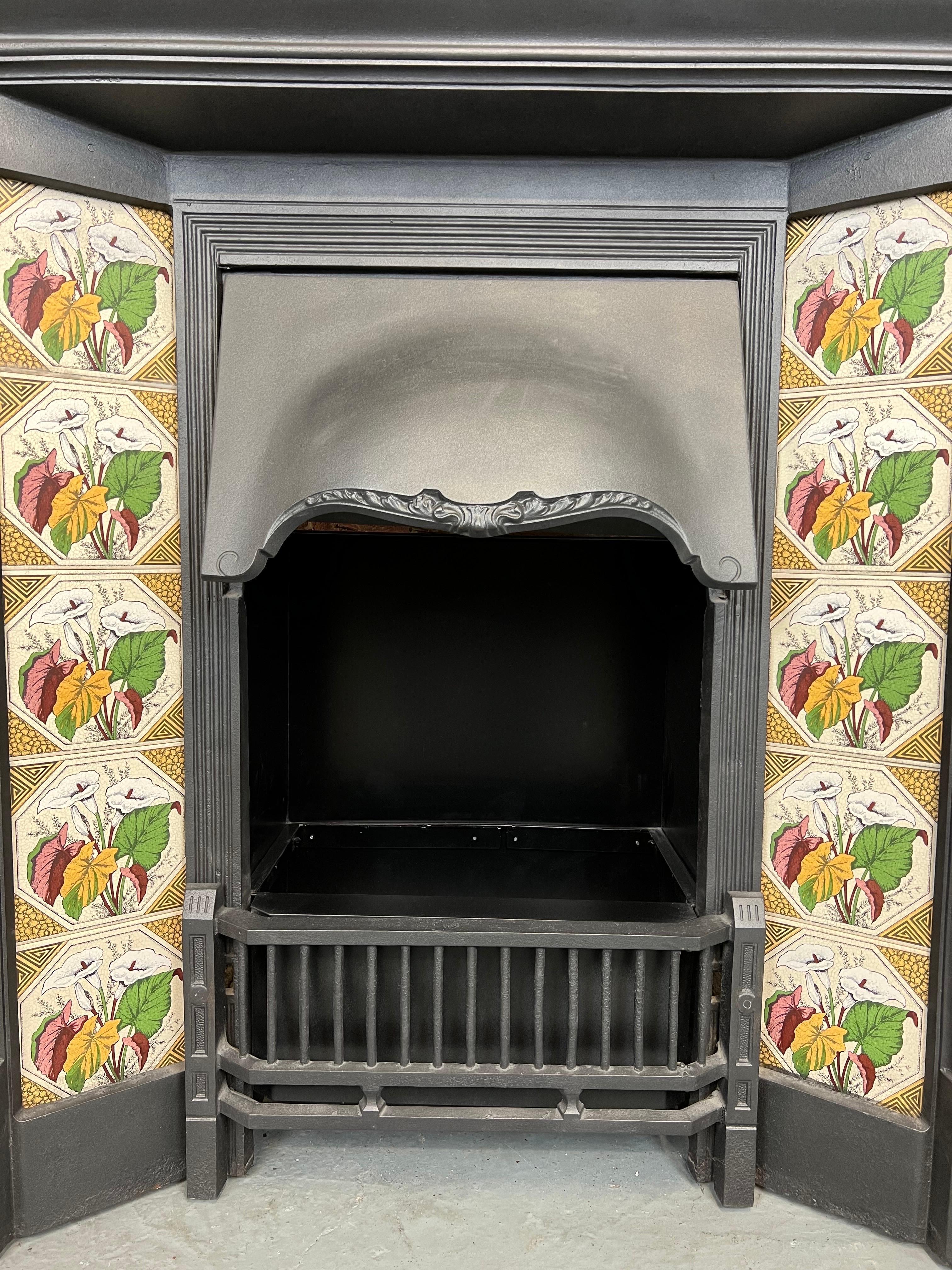19th Century tiled cast iron fireplace combination.
Traditional blackened iron finish. with set of 10 lily tiles.
Including front bars and adjustable canopy hood.
Recently salvaged from a London town house.

Shelf width 40 inch
Heigth
Shelf