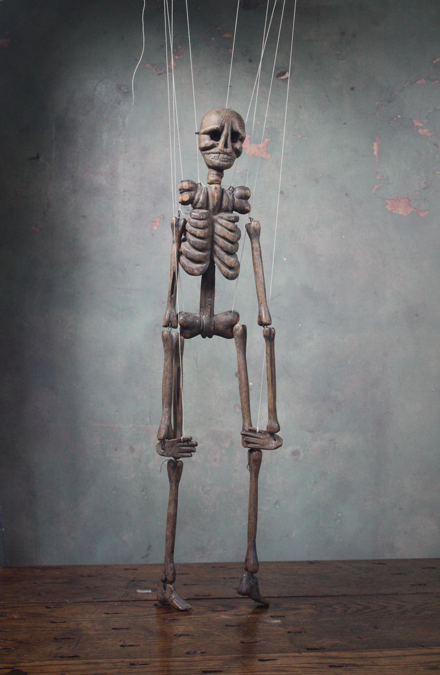 A wonderful piece of English Folk Art. A hand carved Tiller & Clowes trick skeleton marionette circa 1880 in age. The piece would of been used in a large travelling show performed by the two family's who joined forces in 1873.

Marionette shows
