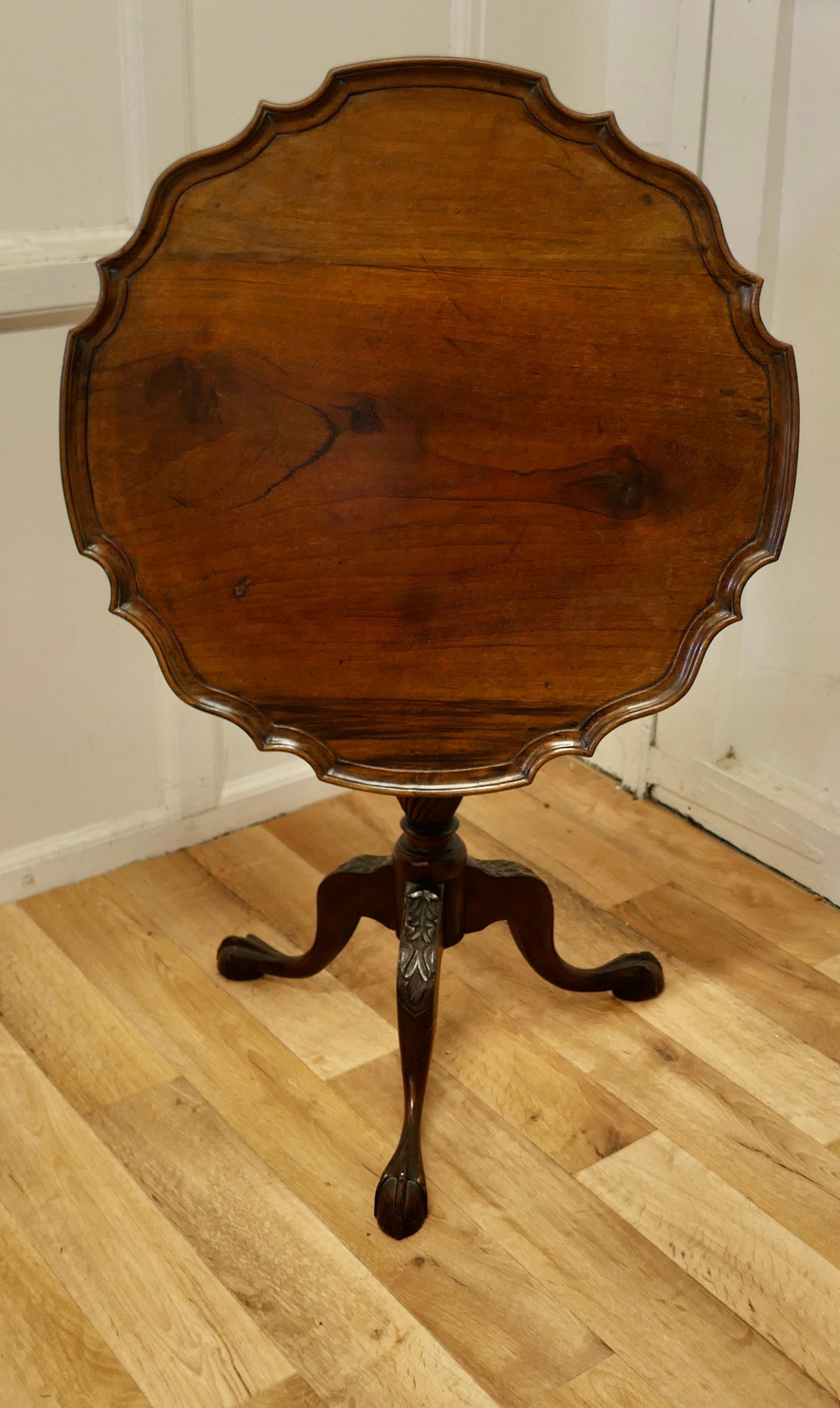 19th Century tilt top wine table.

This lovely table stands on a three footed ball and claw base carved with acanthus leaves at the knees and has a attractive turned centre leg.
The top tilts when space is required and it has a very attractive