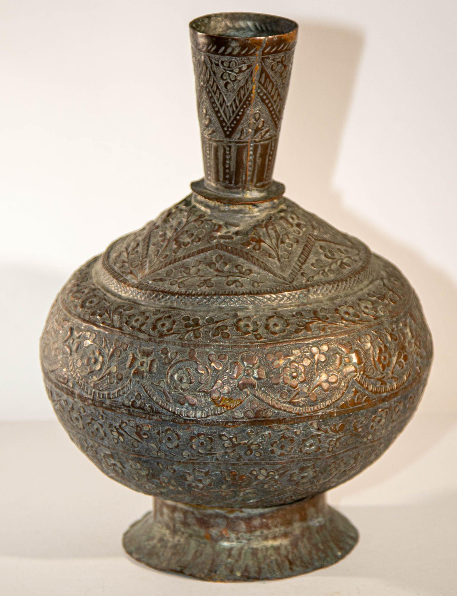 Antique Islamic metal copper hookah bottle base of spherical form and decorated with a recessed repeated floral motif.
19th century Bronze tinned copper Indo-Persian Islamic vase, hand- chased and embossed metal with a very dark patina.
Antique