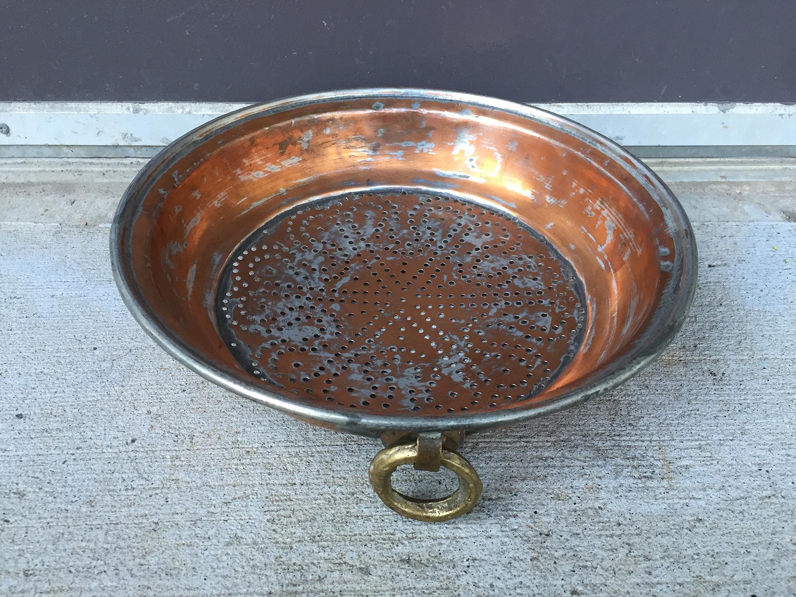 19th century to turn of the century copper strainer with brass handles.