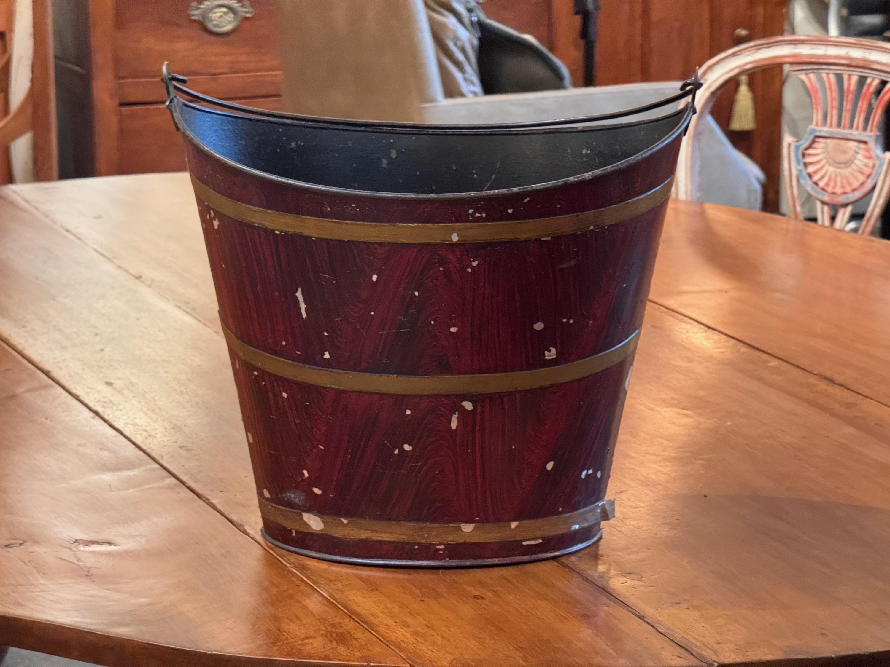 A grain painted tole bucket. Perfect for magazines or kindling.