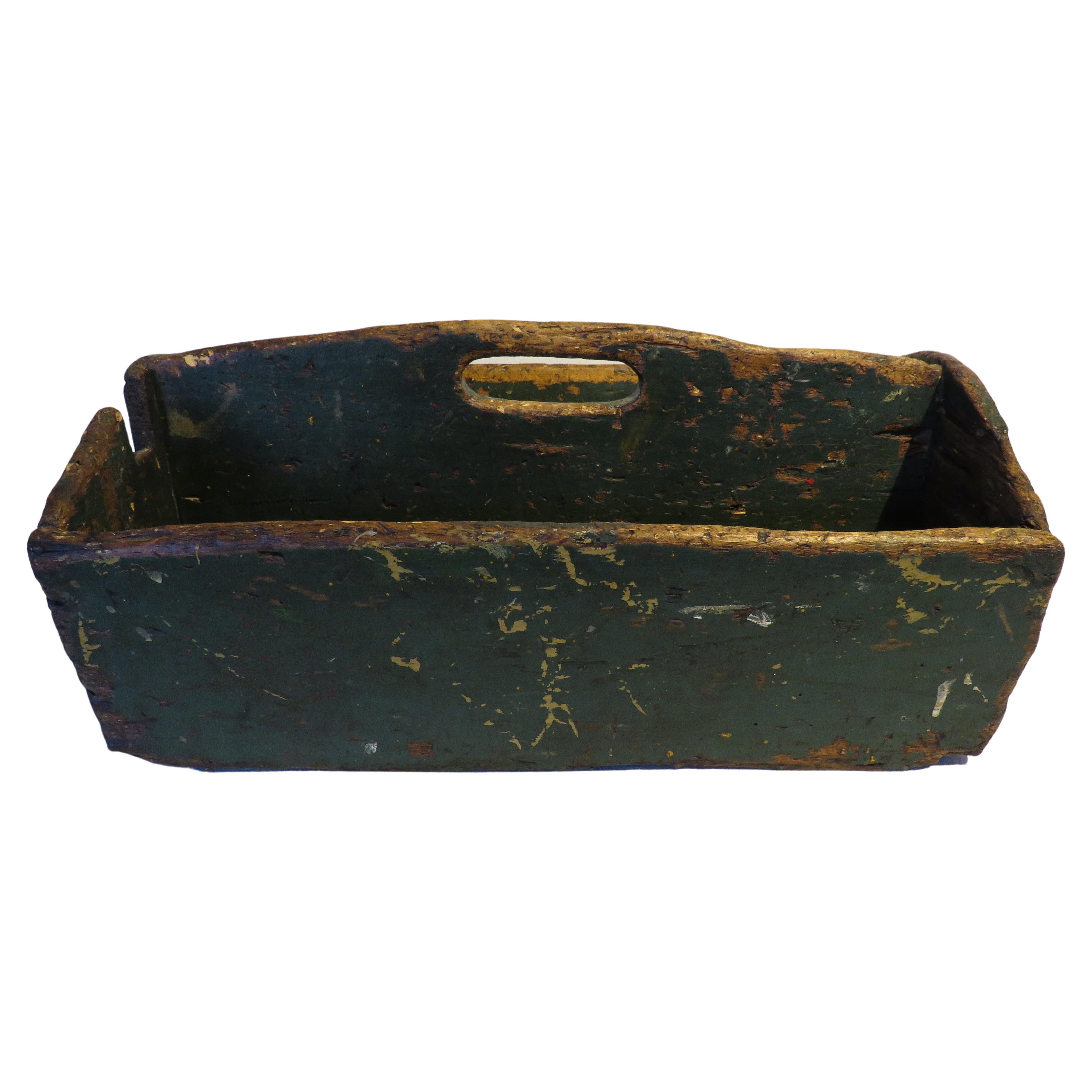 Rustic 19th century tool caddy with two part construction and central carrying handle. One side notched to fit and support a tool. Great original green paint. Wear consistent with age and use.