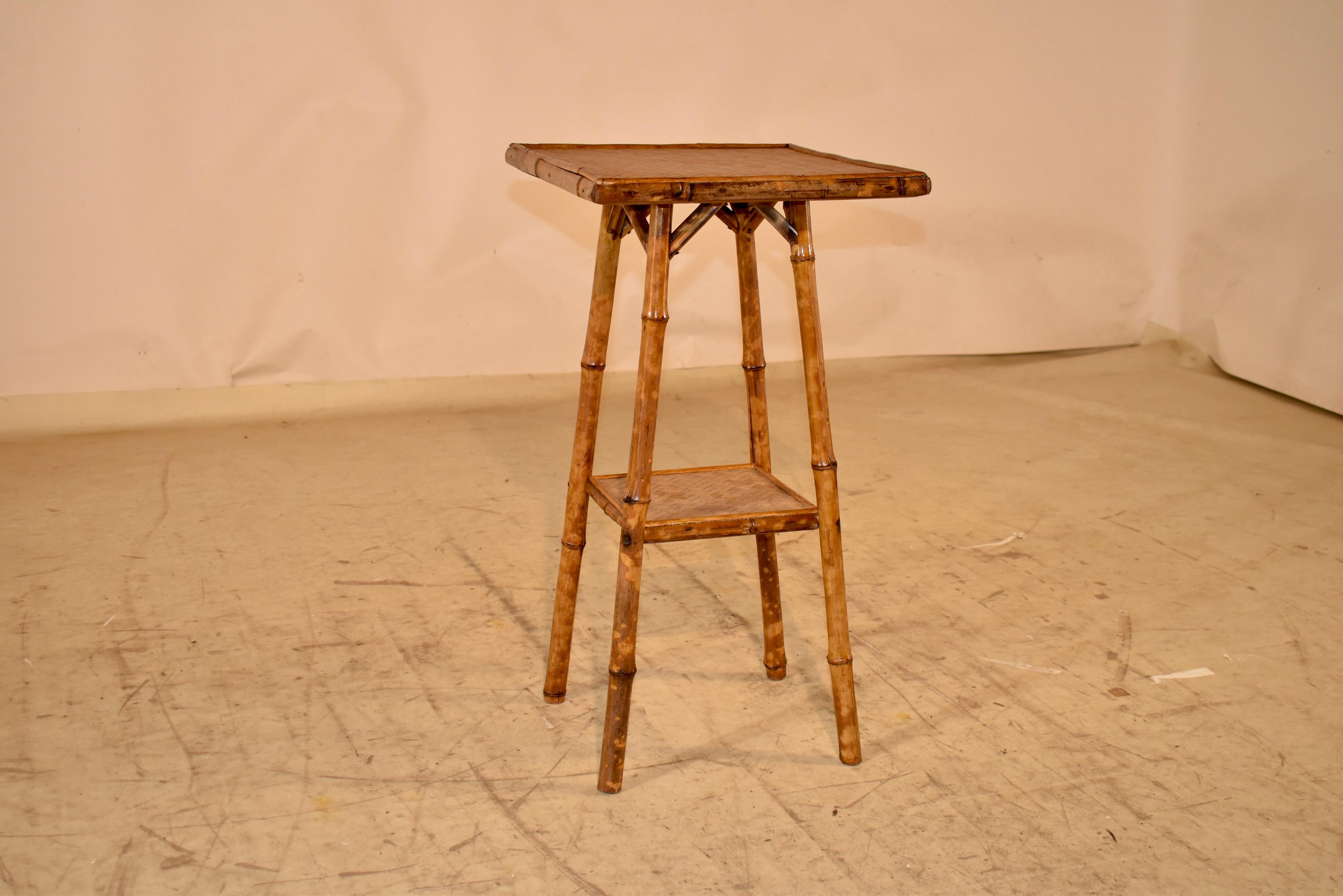 19th century tortoise bamboo side table from France.  The top and lower shelf are covered in herringbone textile for added design interest.  The table is supported on splayed legs, which are joined by the lower shelf.  This is a wonderful small side
