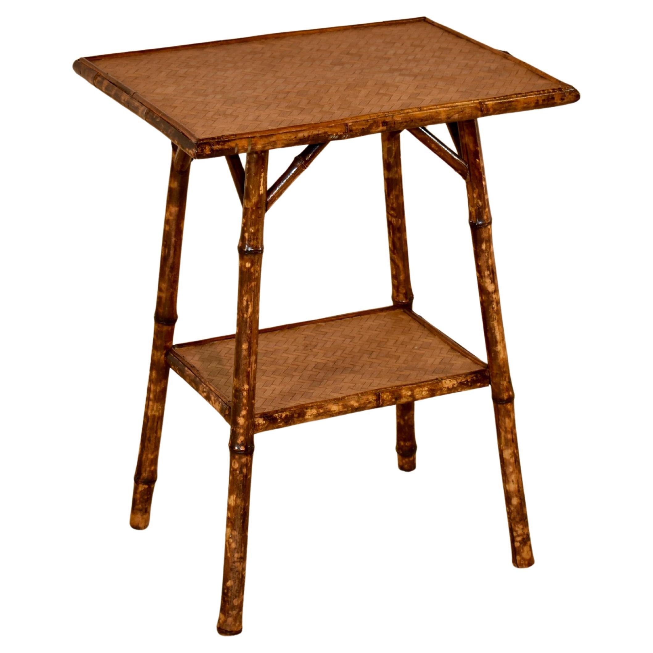 19th century tortoise bamboo side table from France.  The top has been restored and is supported on splayed legs, joined by a lower shelf, which has also been restored.  These side tables are wonderfully stylish and always elegant for any decor.