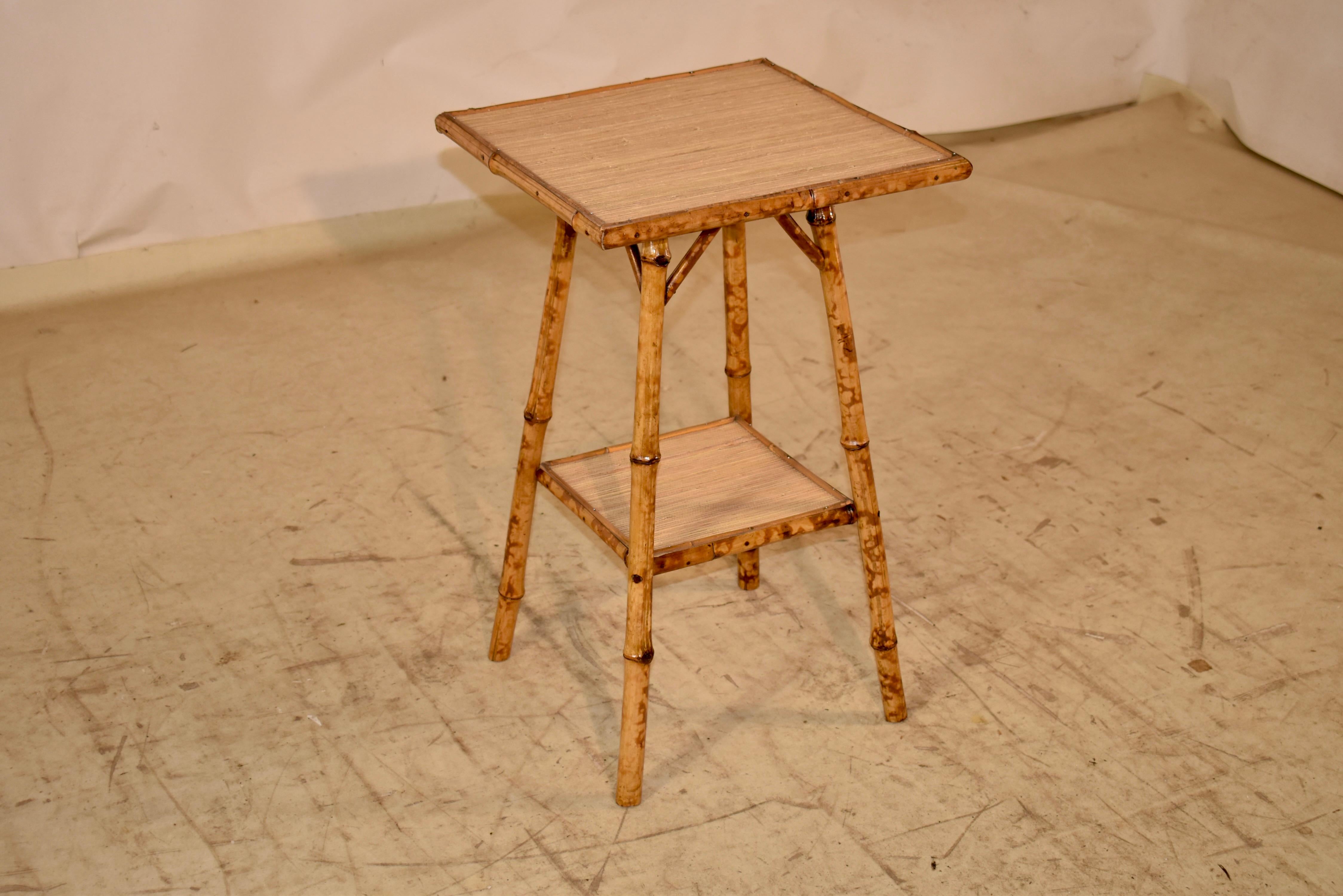 Late 19th century tortoise bamboo side table from France.  The top and lower shelf are covered in seagrass, for added texture.  The table is supported on splayed legs, joined by the lower shelf.  This table will be a wonderful addition to any