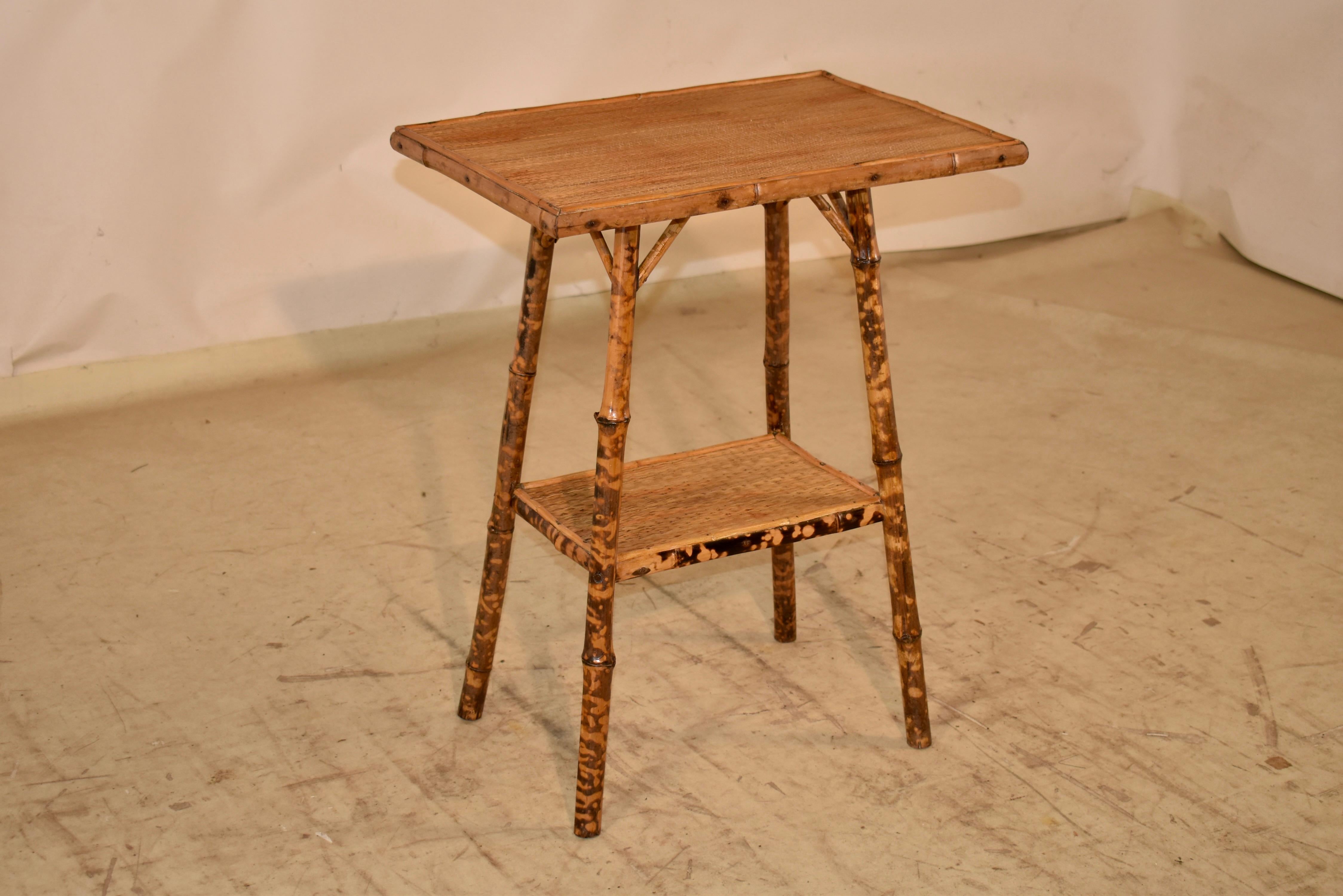 19th century tortoise bamboo side table from France .  The top I sanded in bamboo molding, and is supported on splayed legs, joined by a lower shelf.  The top and lower shelf are covered in rush.  These are lovely small tables which are easy to