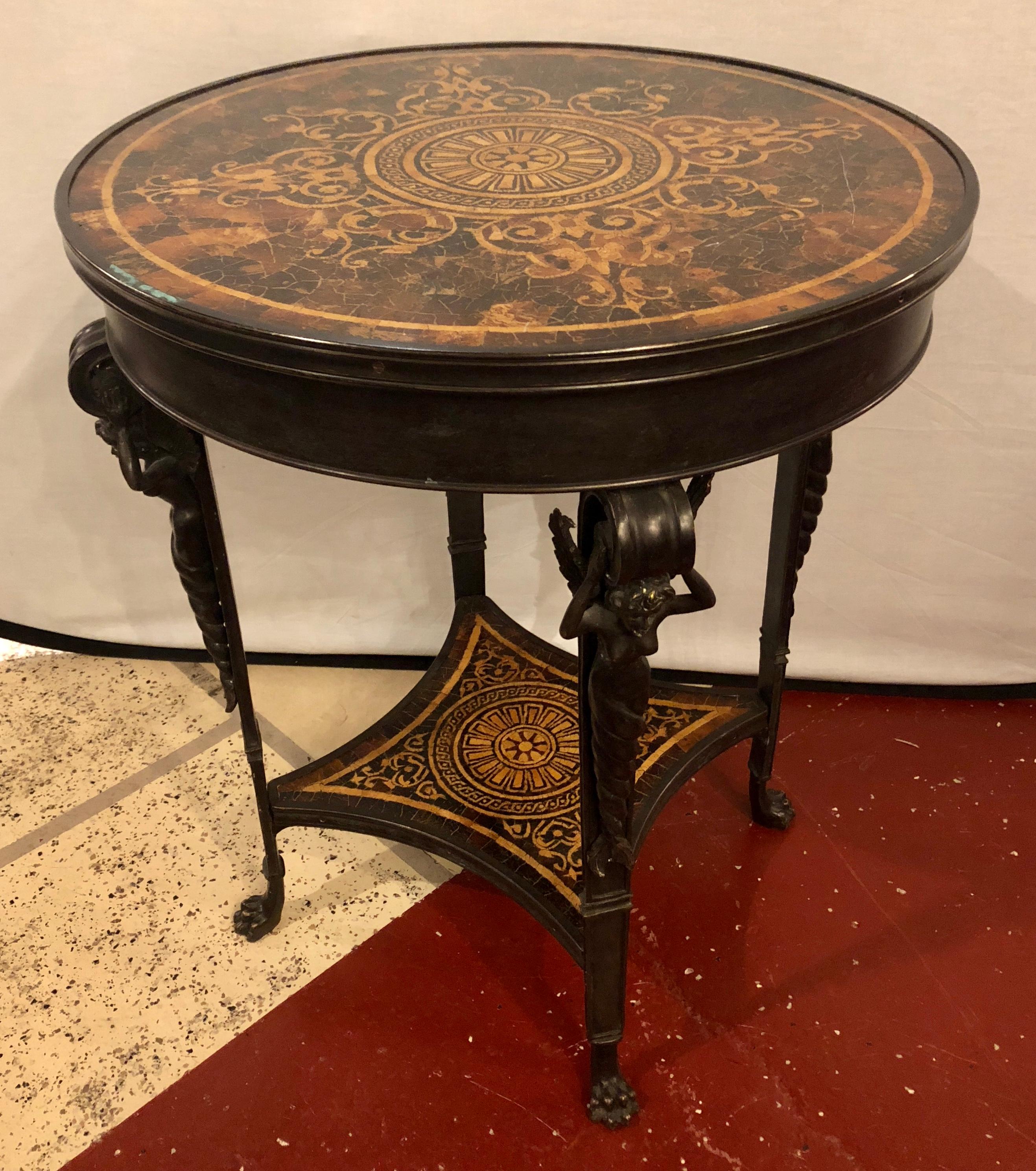 19th century tortoiseshell top bronze figural center or end lamp table. This one of a kind table has winged bronze figures on the corners supporting a tortoiseshell form tabletop. 

EXXX.