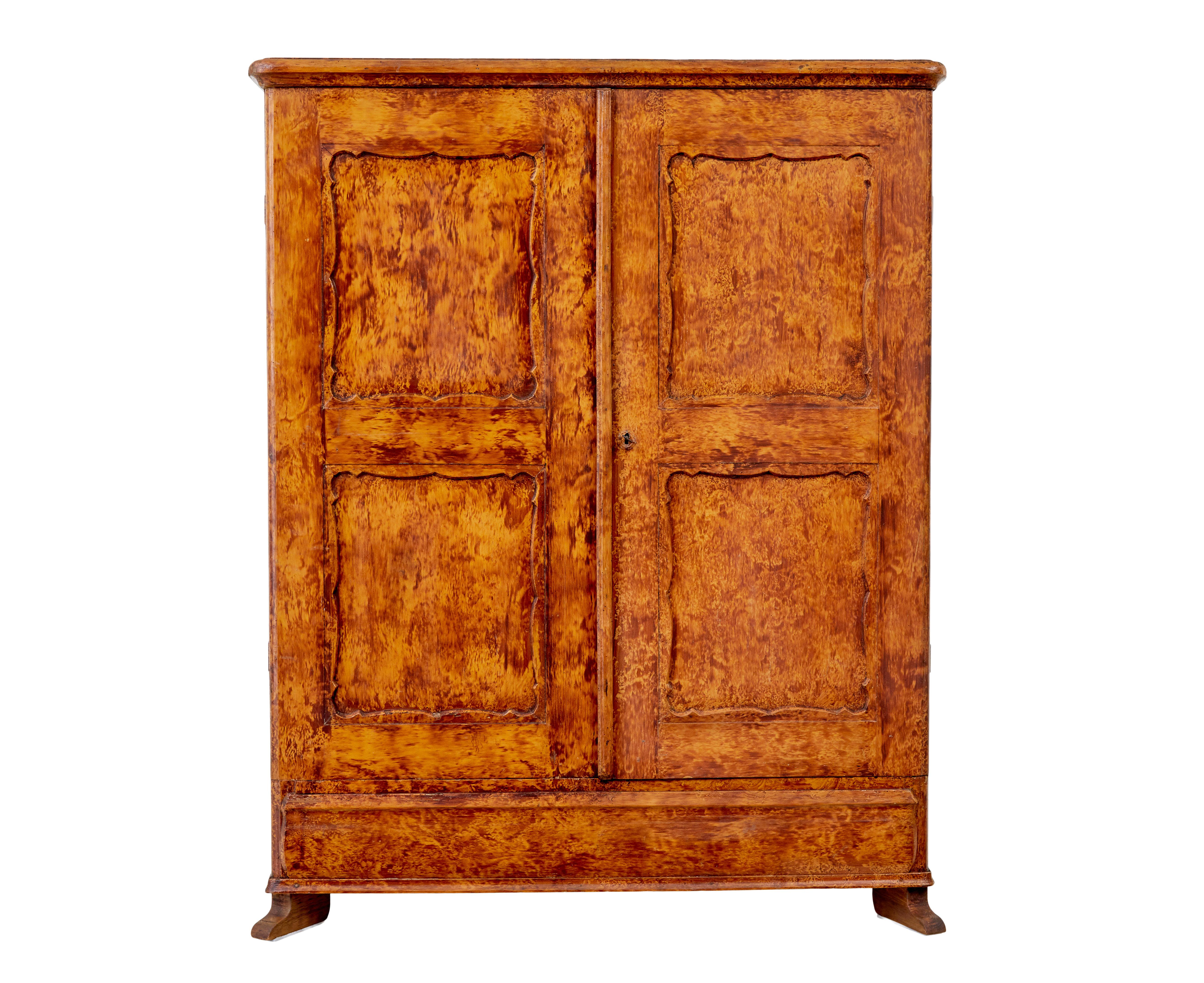 Good quality traditional Swedish cupboard circa 1860.

Presented in its original rag work paint effect.  Double doors open to reveal a partially fitted interior which indicates this was being used as a wardrobe.

2 shelves and 4 drawers, also a