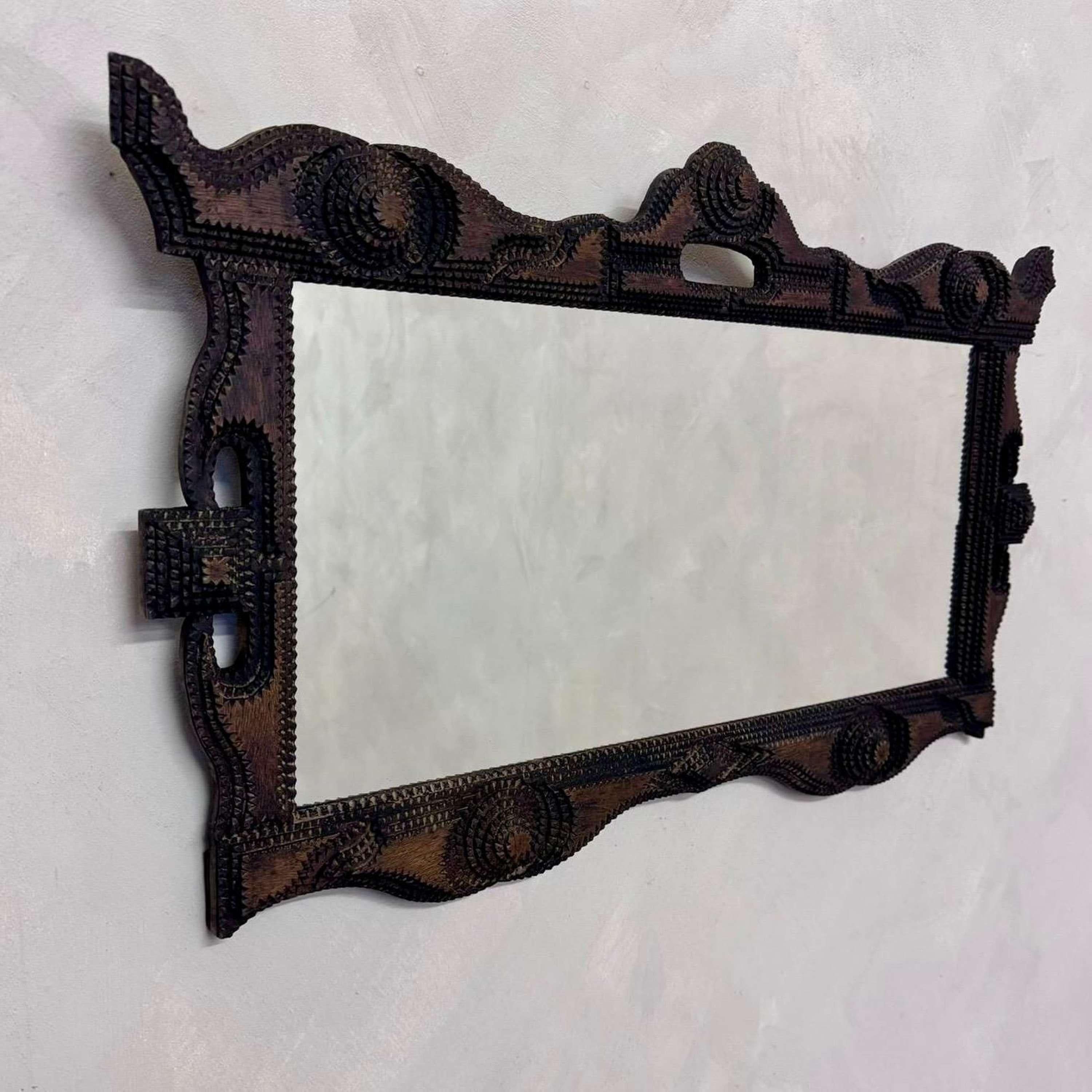 A highly decorative example of a 19th century Tramp Art Mirror.
Mirror plate recently added, with a fitted back panel by our professional framer.
Tramp Art is a style of woodworking which emerged in America in the latter half of the 19th century.