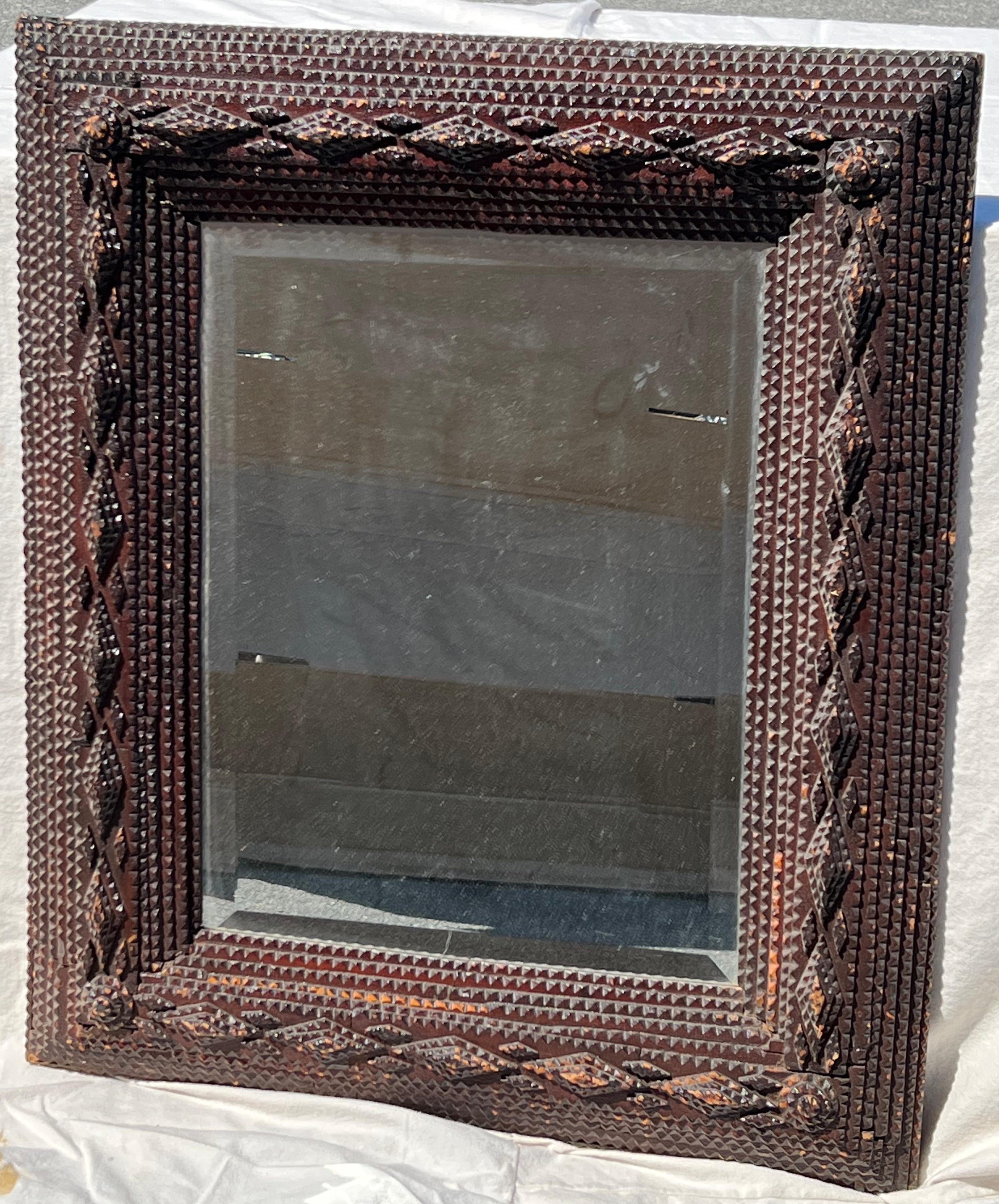 Late 19th century Tramp Art frame with applied, stepped, chip-carved surface displaying diamond patterns and rosettes at corners. Great old surface with later inset mirror.