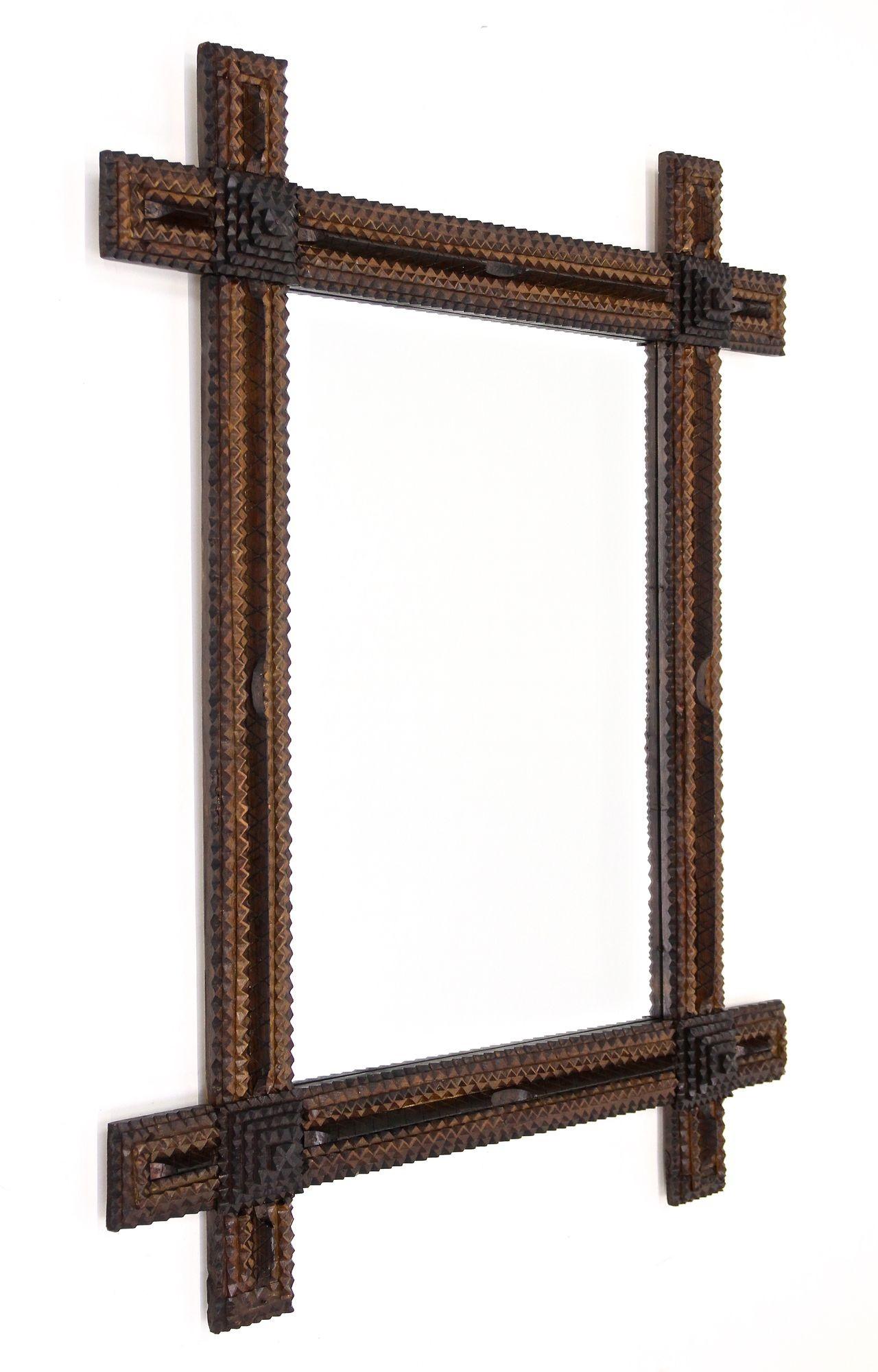 Absolutely exceptional, very large rustic Tramp Art wall mirror from the late 19th century around 1870 in Austria. This very special handcrafted, elaborately made rural wall mirror impresses with its amazing looking variety of different elements: