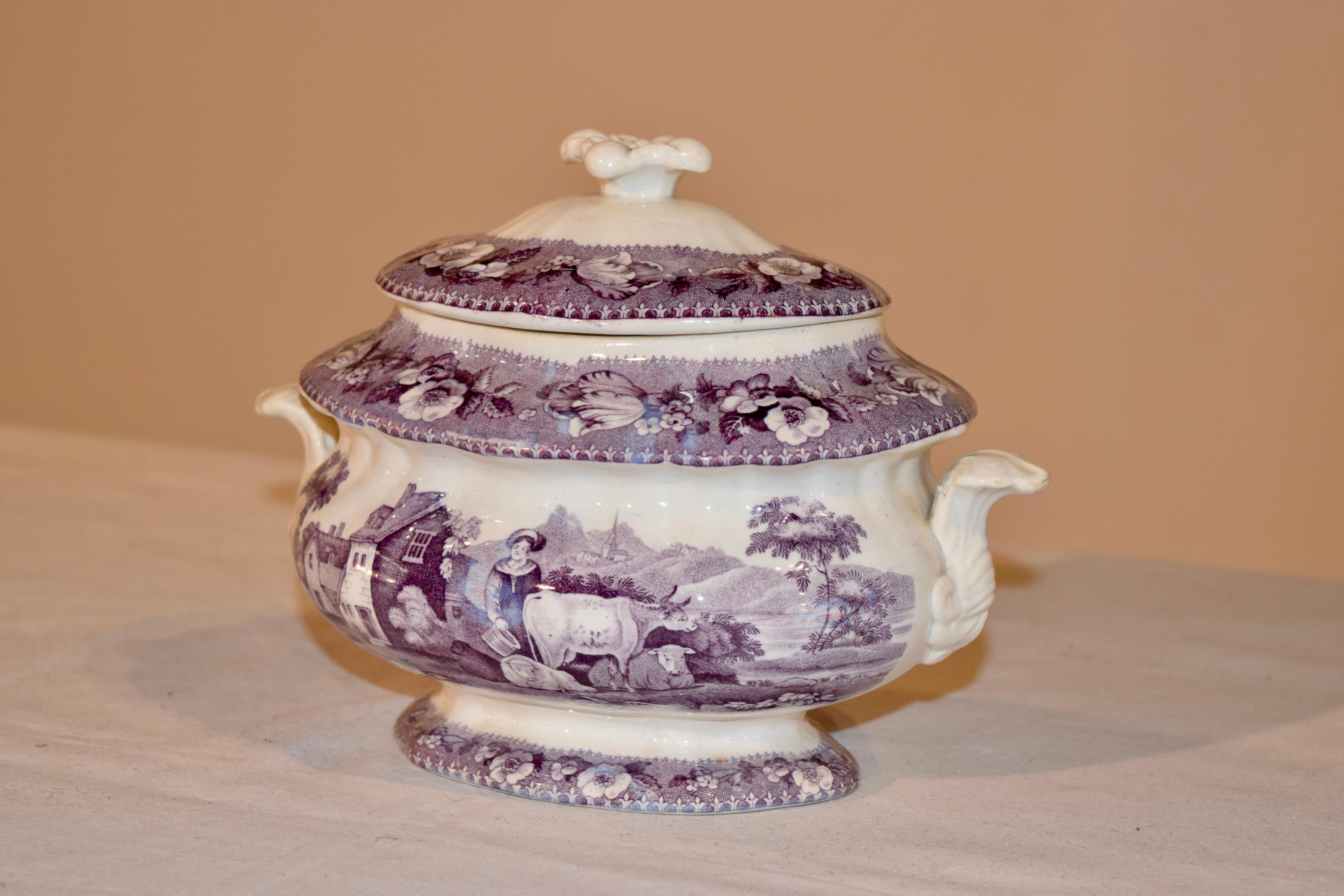 19th century transferware sugar bowl from Staffordshire, England. The pattern is a rich purple color depicting a pastoral scene with a farmhouse in the background and in the foreground a milk maid and a surrounding of cows. Marked with impressed