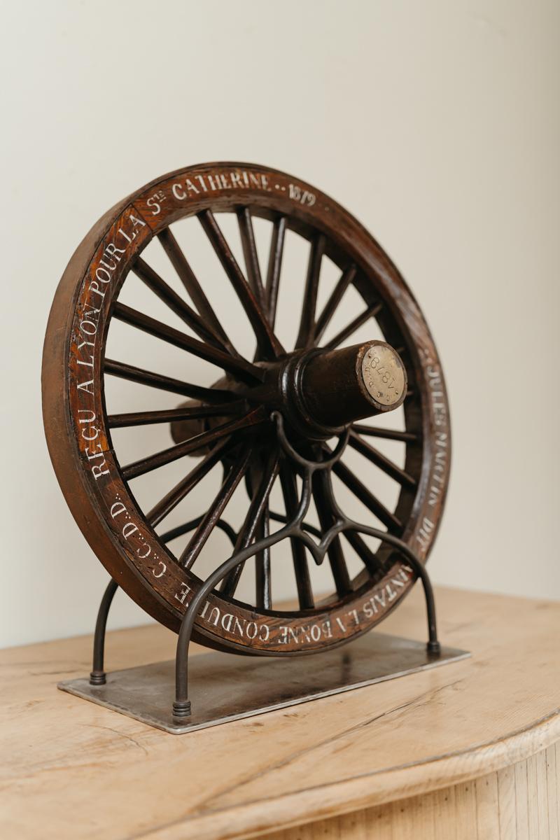 A true collectors item, this travail de maîtrise/master's work, made in France in the 19th century, dated 1879, a wooden three spoke wheel, mounted on a contemporary iron base, a rare found.
 
