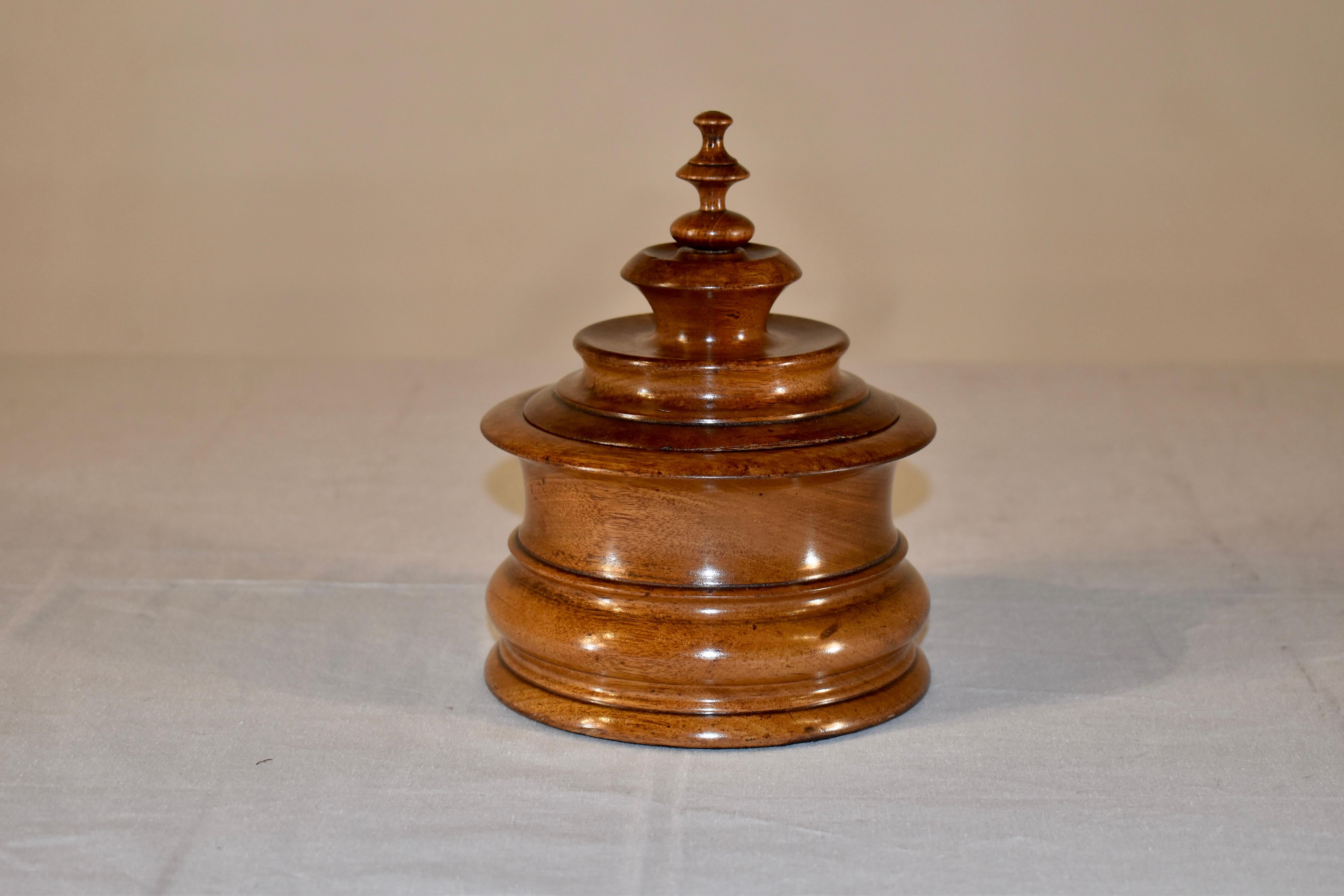 19th century hand turned treen tobacco box made from walnut.  The lid is expertly turned and is topped with a finial over a fabulous hand turned base.  The walnut is a handsome color and has acquired a rich patina from age and use.  This is a