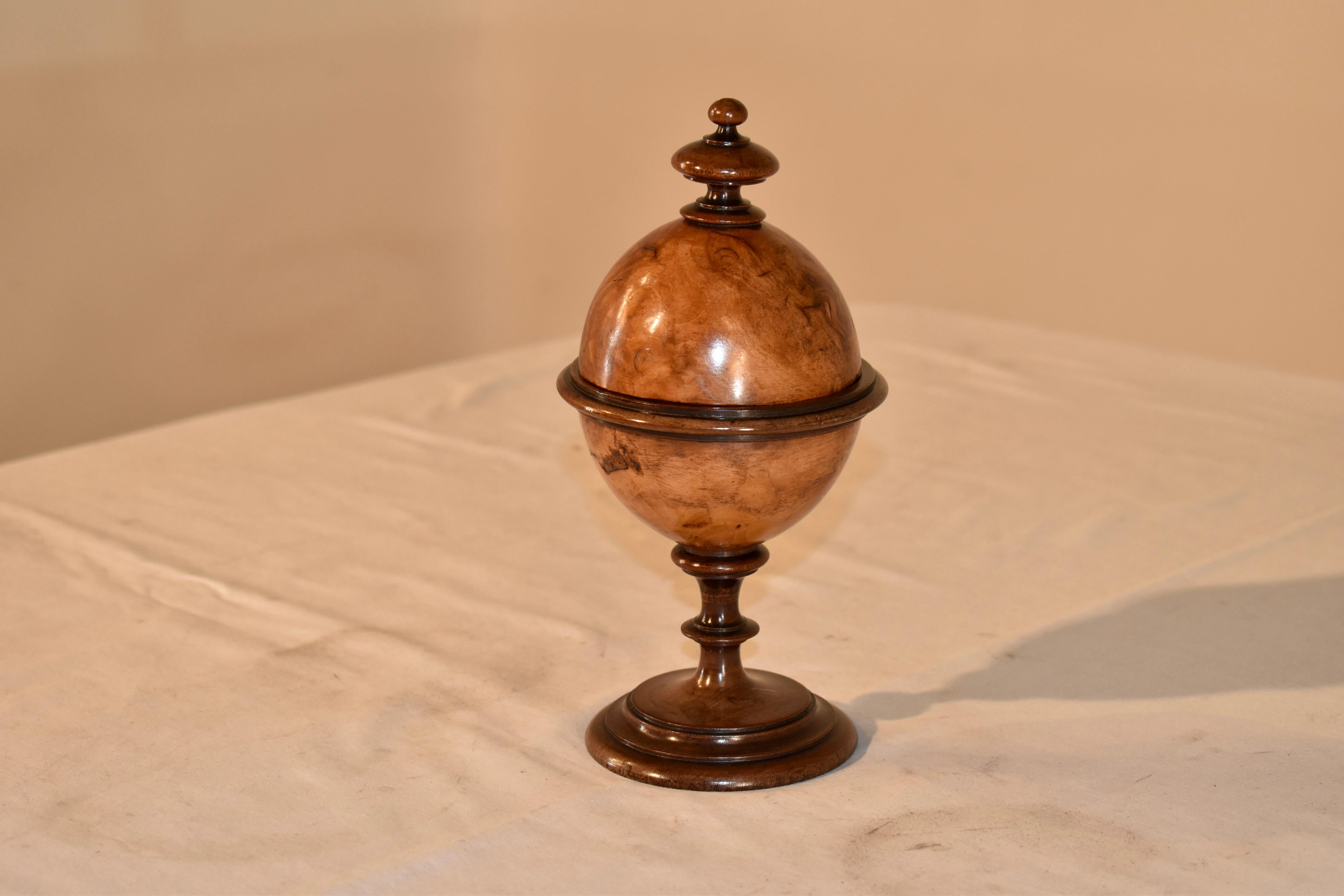 Early 19th century turned treen ware burl walnut lidded oval box on stand from England.  The top is decorated with a turned finial and sits atop a lovely burl walnut box on a turned walnut stand.  These are wonderful accents for a mantle or in a