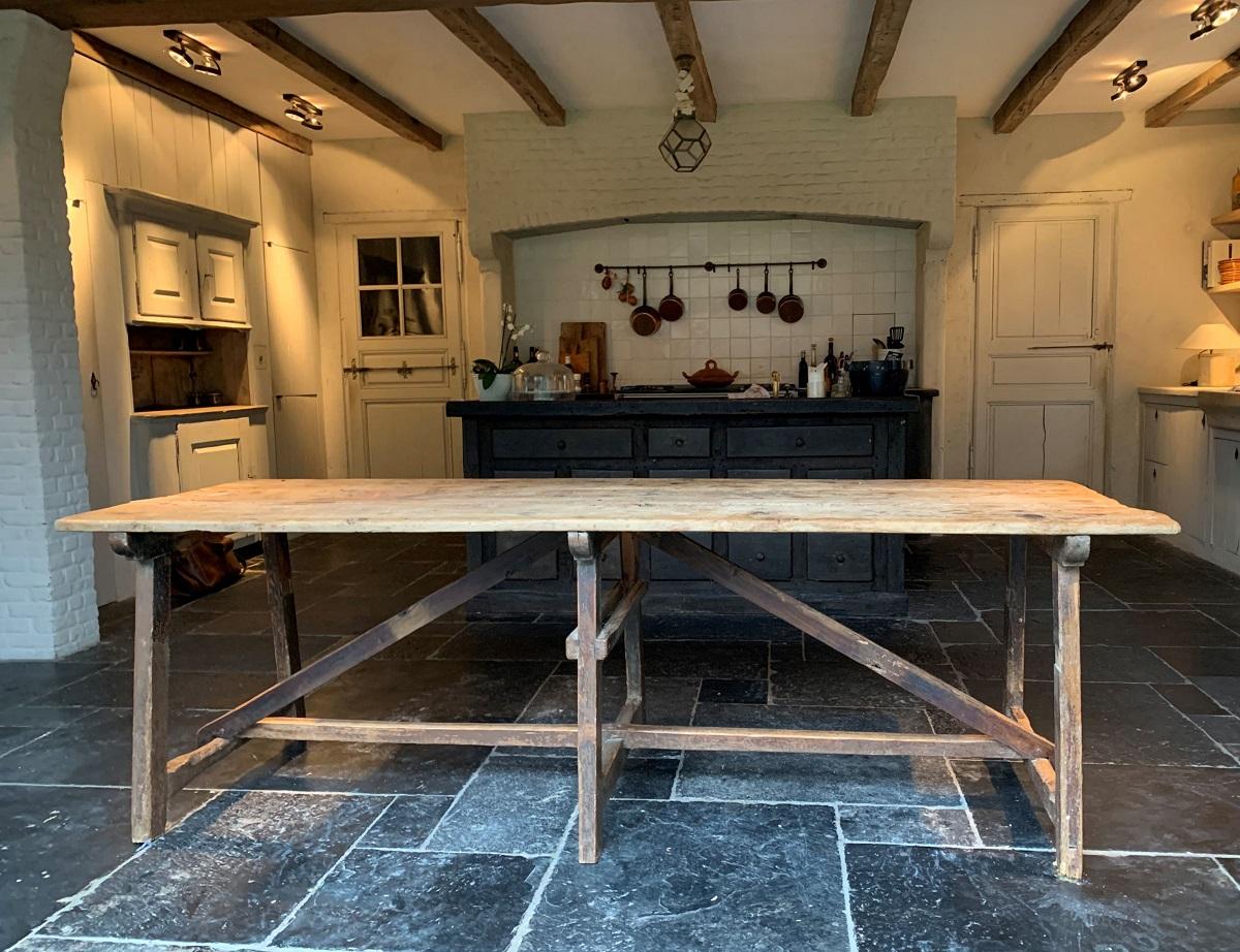A 19th century softwood trestletable from the Pyrinee Mountains (French-Spain). The top in 3 boards of mountain pine fixed with hand forged nails to supports with original paint remnants. Lots of patine but verry sturdy.