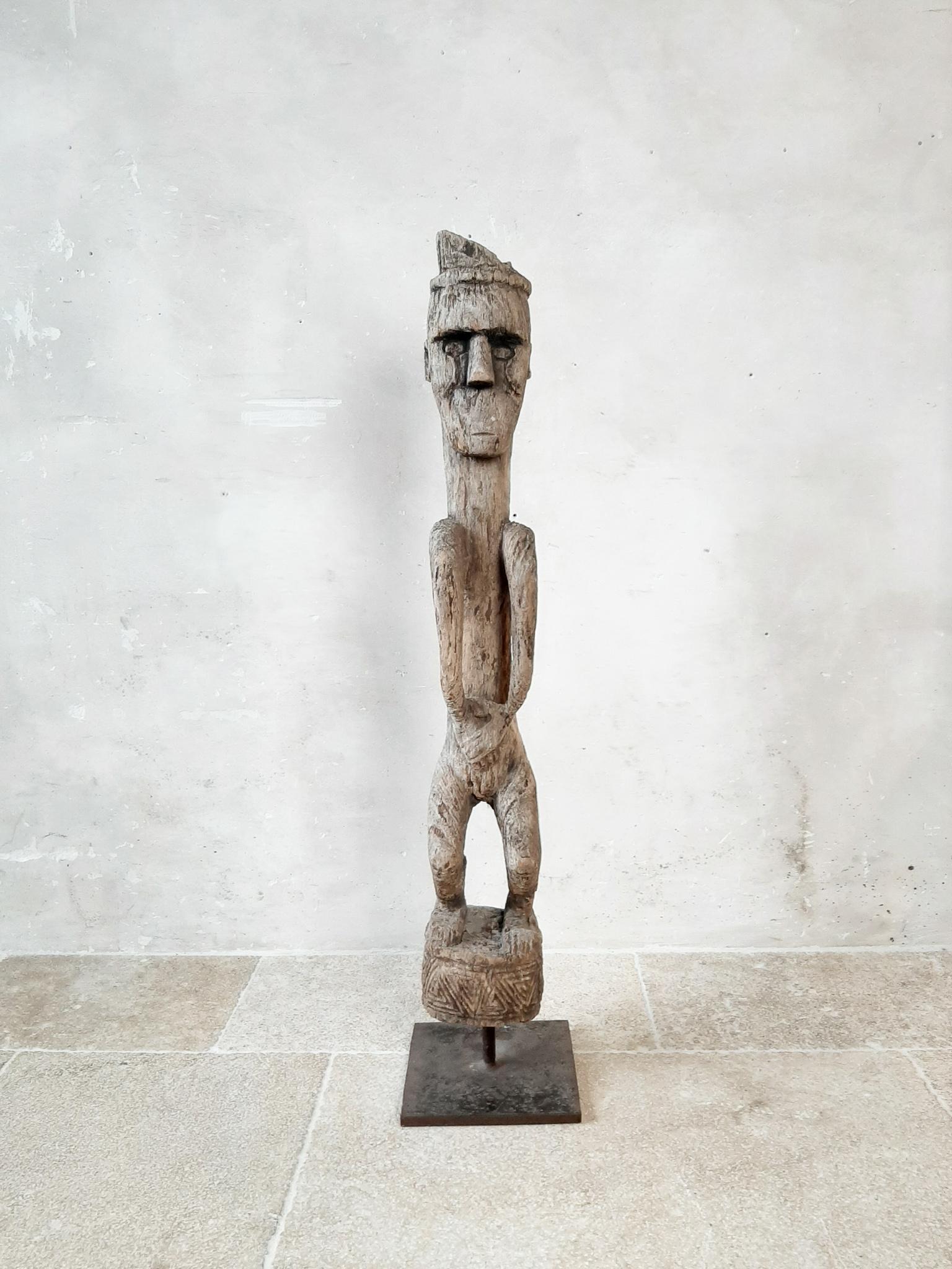 A 19th century tribal handcarved wood Ancestral figure. 
 
Asian African Art, this sculpture is one like a Myanmar / Jorai / Hampatong / Hemba tribe funurary figures. The male statue has a height of 89 cm (without the iron foot), is standing on a